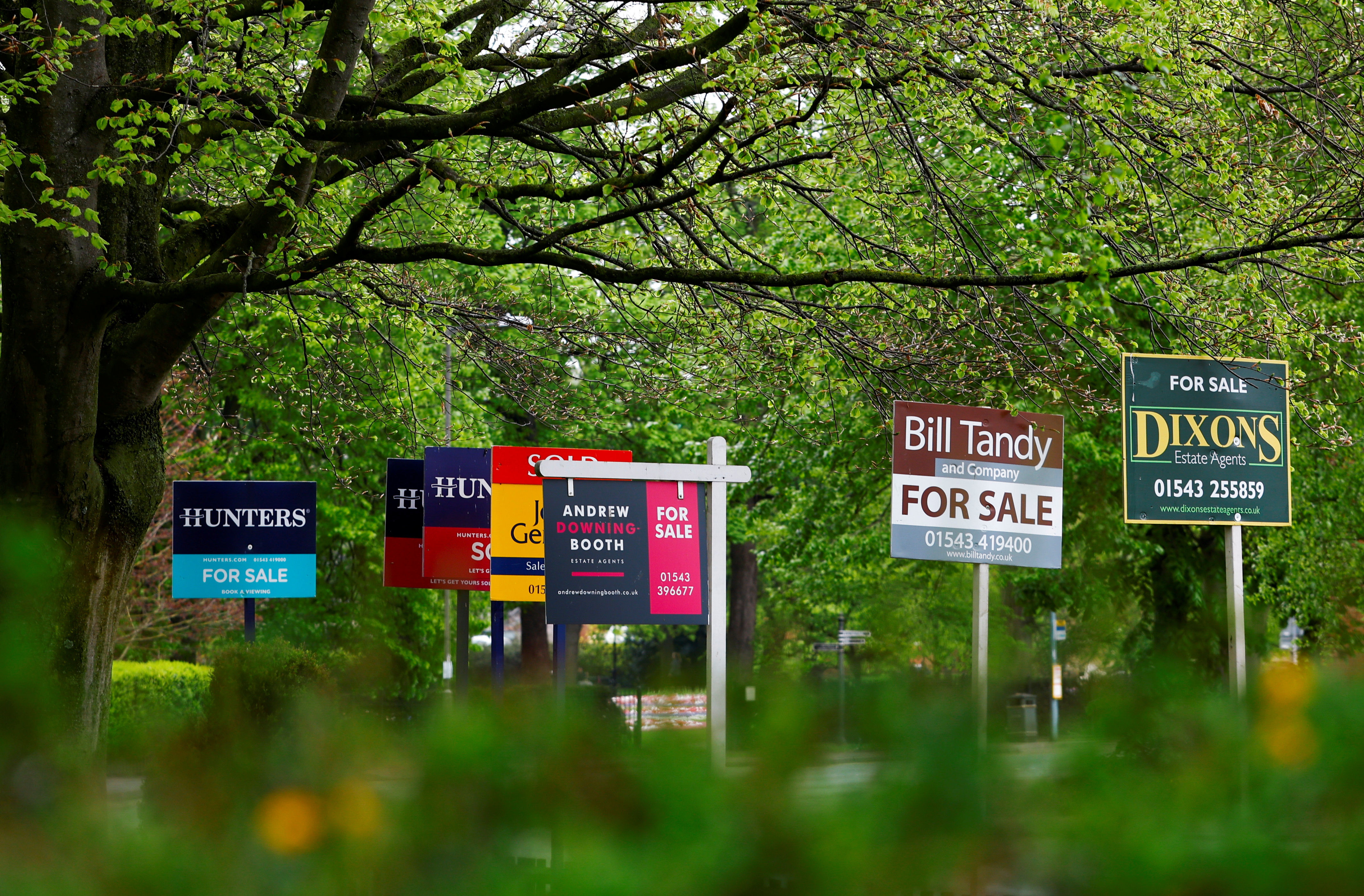 Property estate agent sales and letting signs are seen outside an apartment building