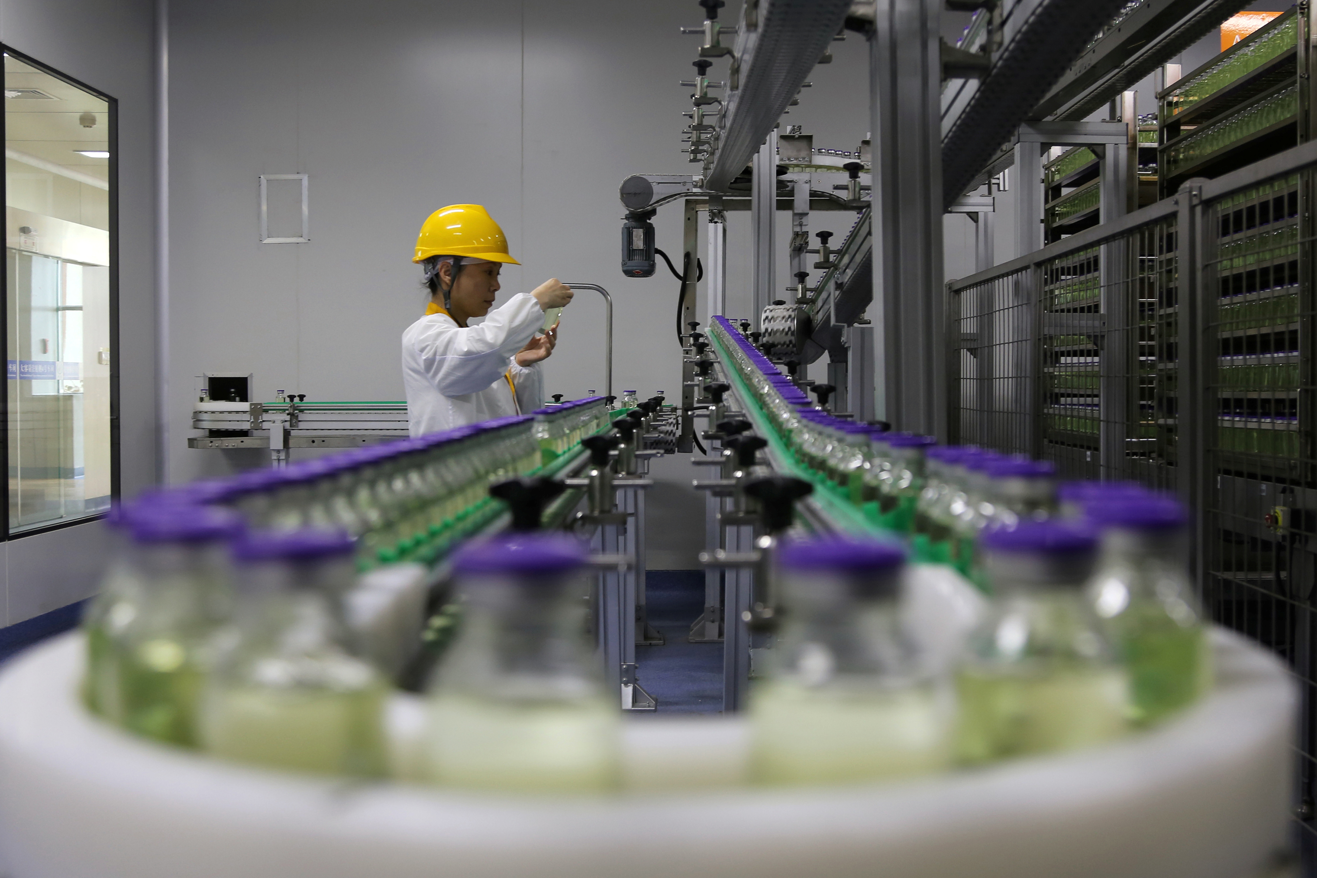 Employee works on a production line manufacturing drugs at the Yangtze River Pharmaceutical Group in Taizhou, Jiangsu