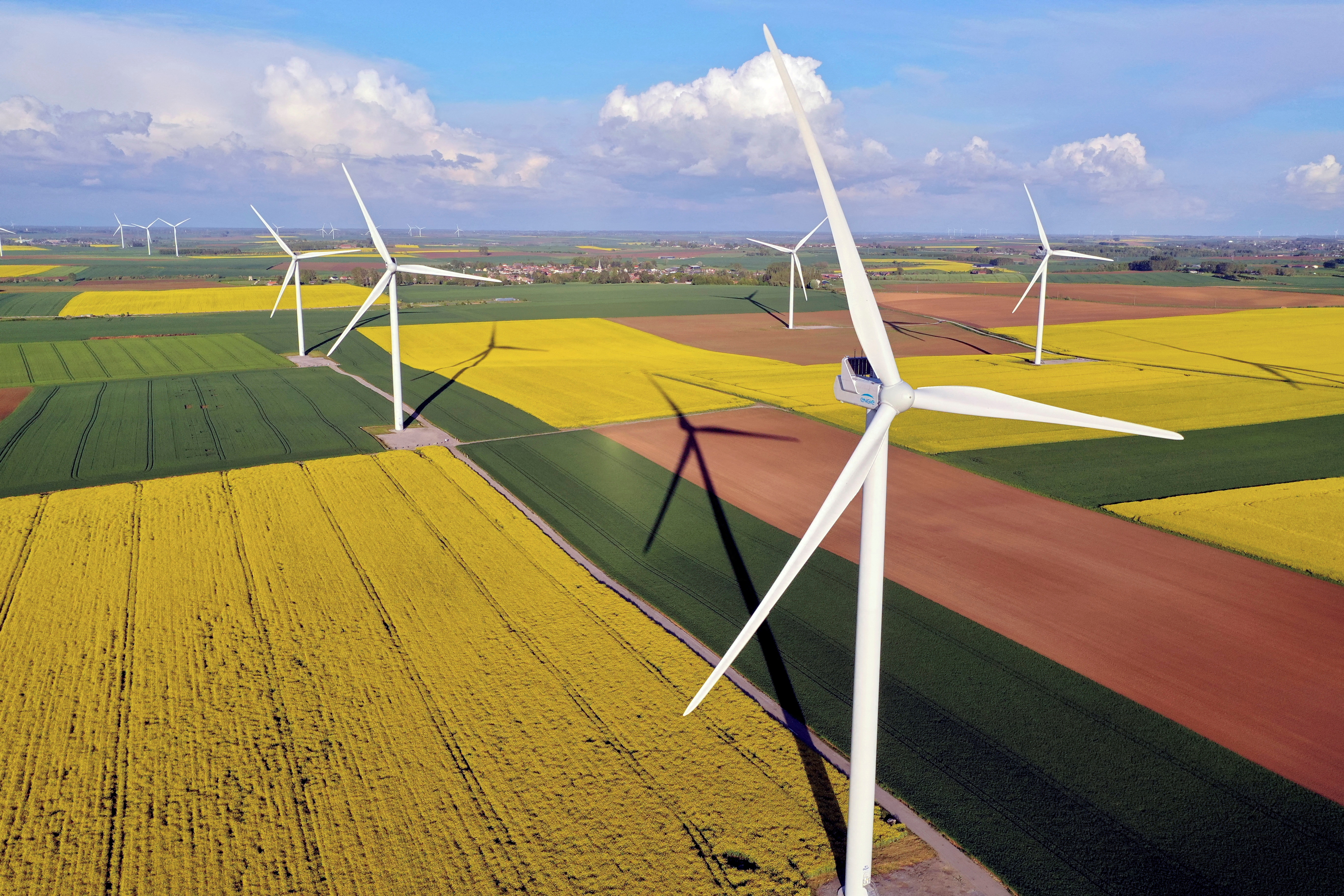 An aerial view shows Engie Green power-generating windmill turbines in the middle of rapeseed and wheat fields, in Saint-Hilaire-lez-Cambrai