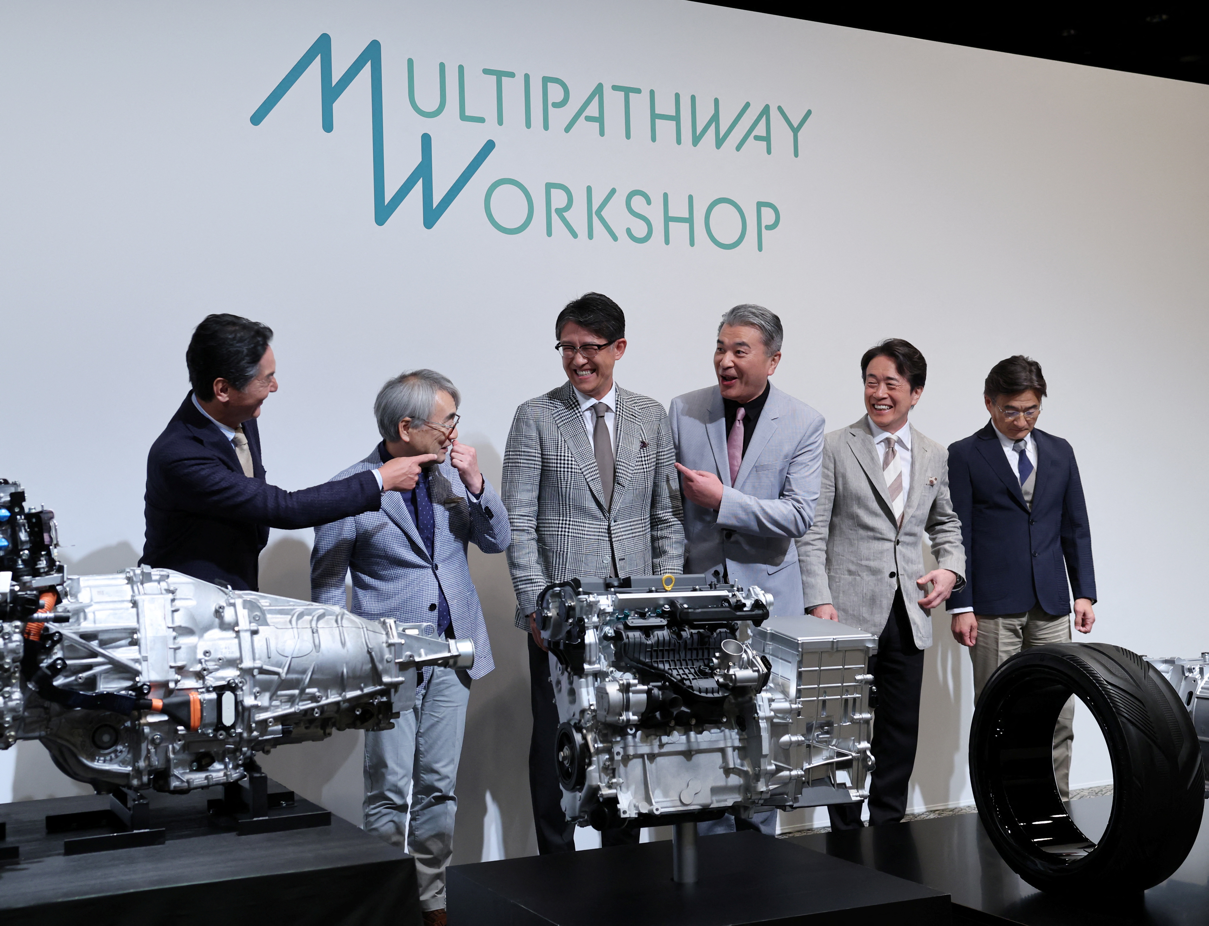 Subaru's CEO Atsushi Osaki, CTO Tetsuo Fujinuki, Toyota's CEO Koji Sato, CTO Hiroki Nakajima, Mazda's CEO Masahiro Moro and CTO Ichiro Hirose chat during a photo session at a press conference, in Tokyo