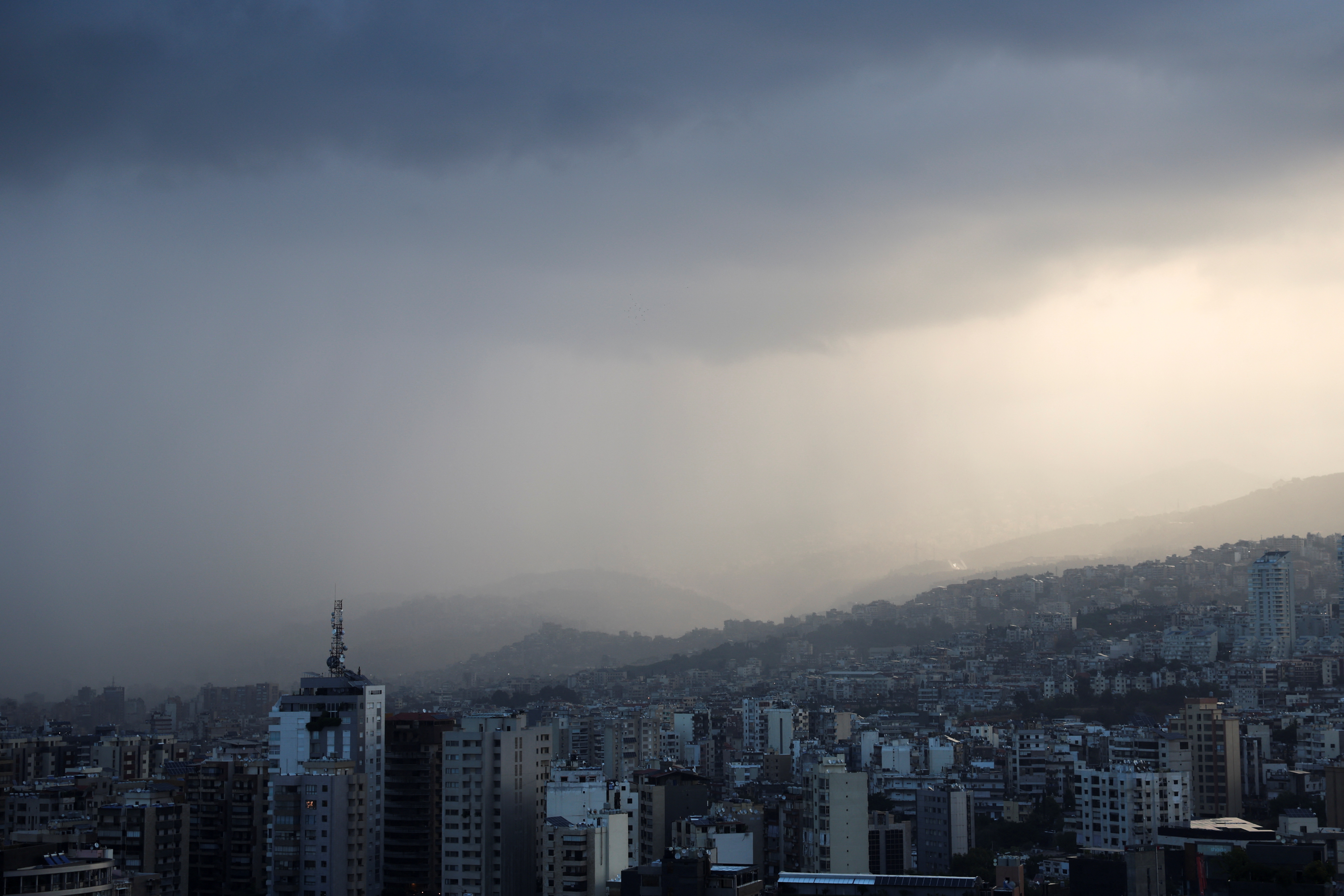 Dark clouds blanket the sky over Beirut suburbs during heavy rain