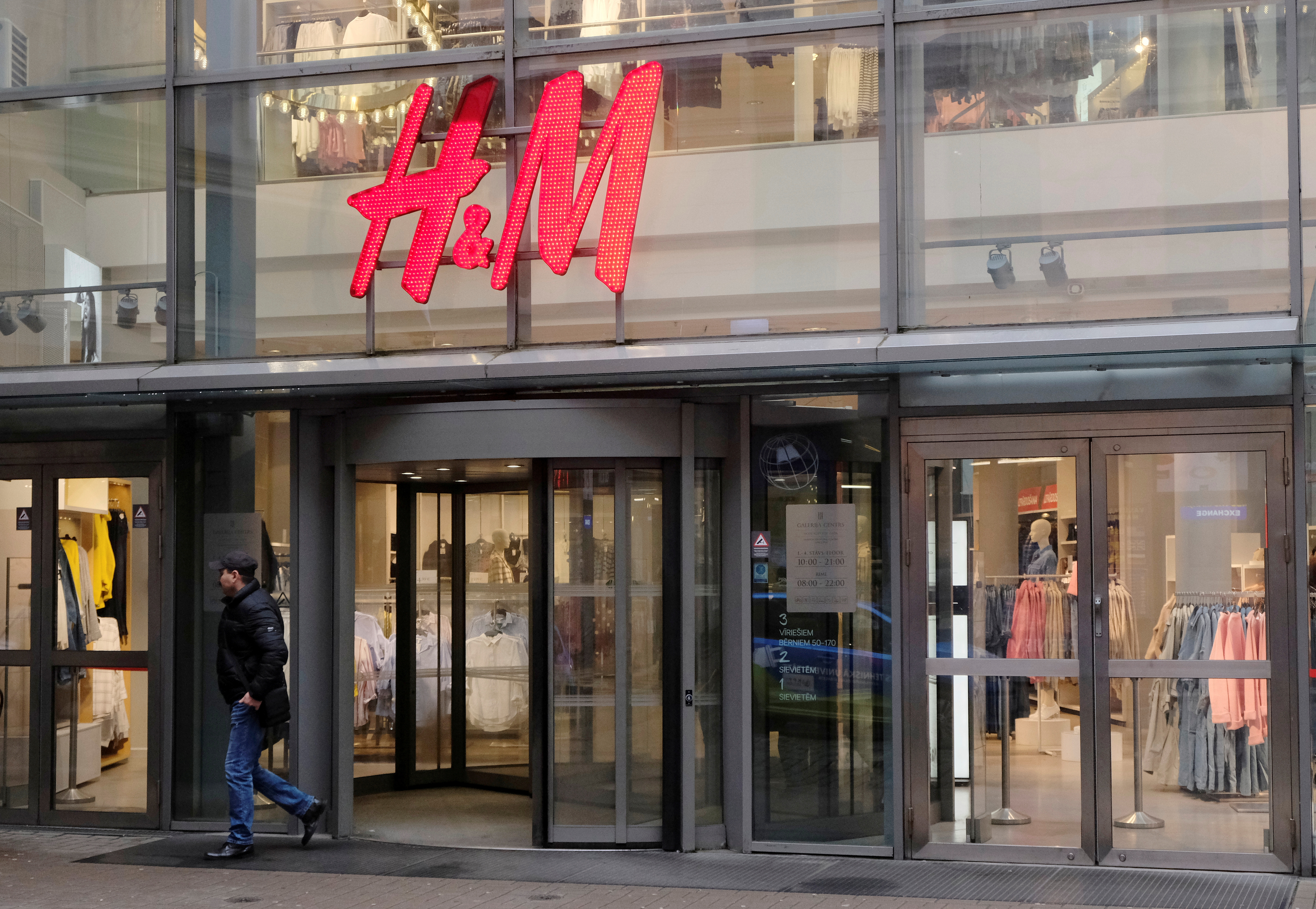 A man leaves H&M shop in Riga