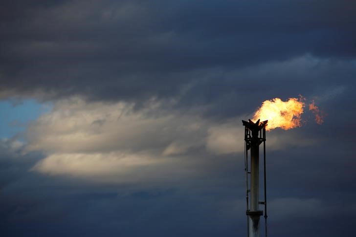 A flare burns off excess gas from a gas plant in the Permian Basin in Loving County