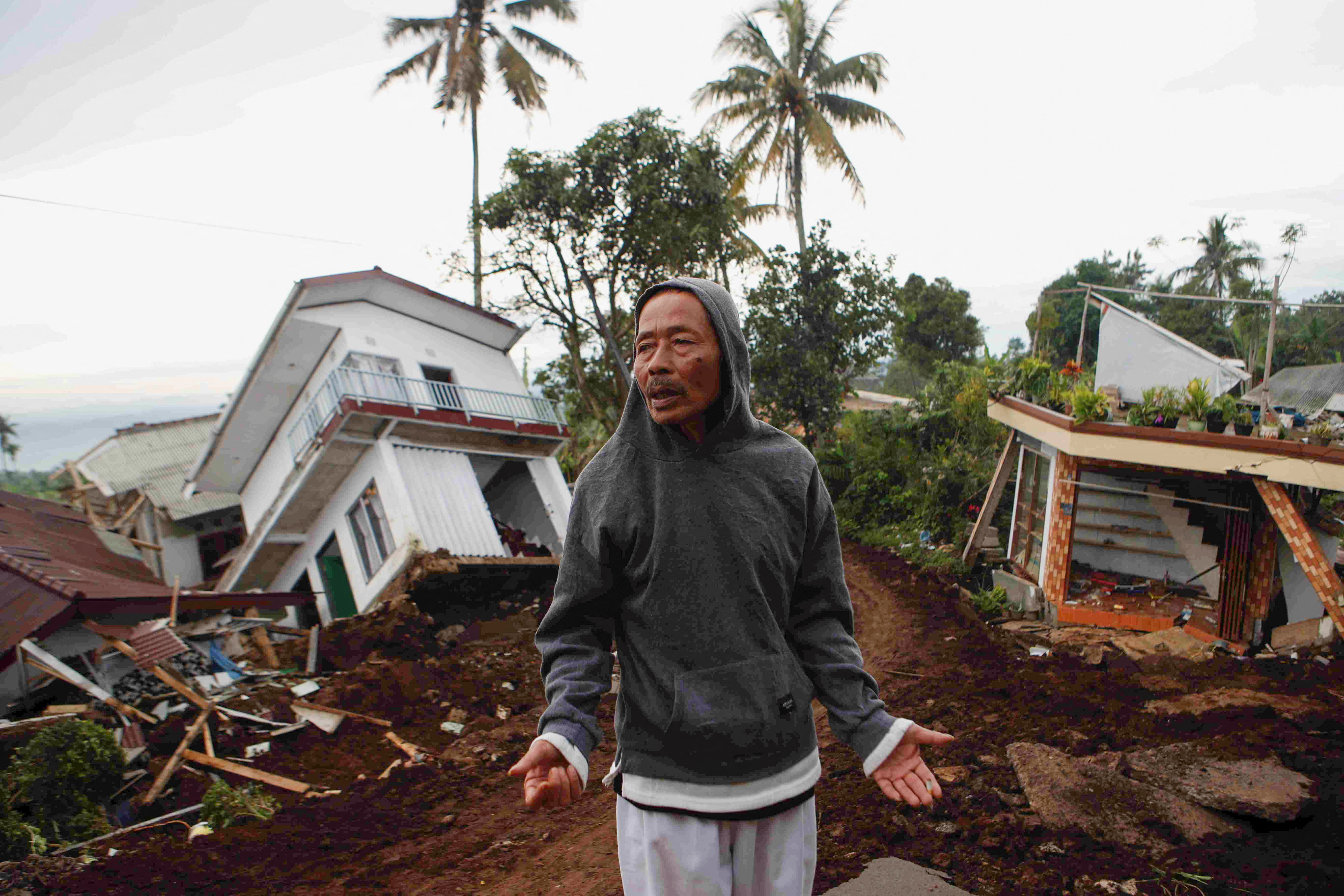 Badri stands near badly damaged houses after Monday's earthquake hit Cianjur