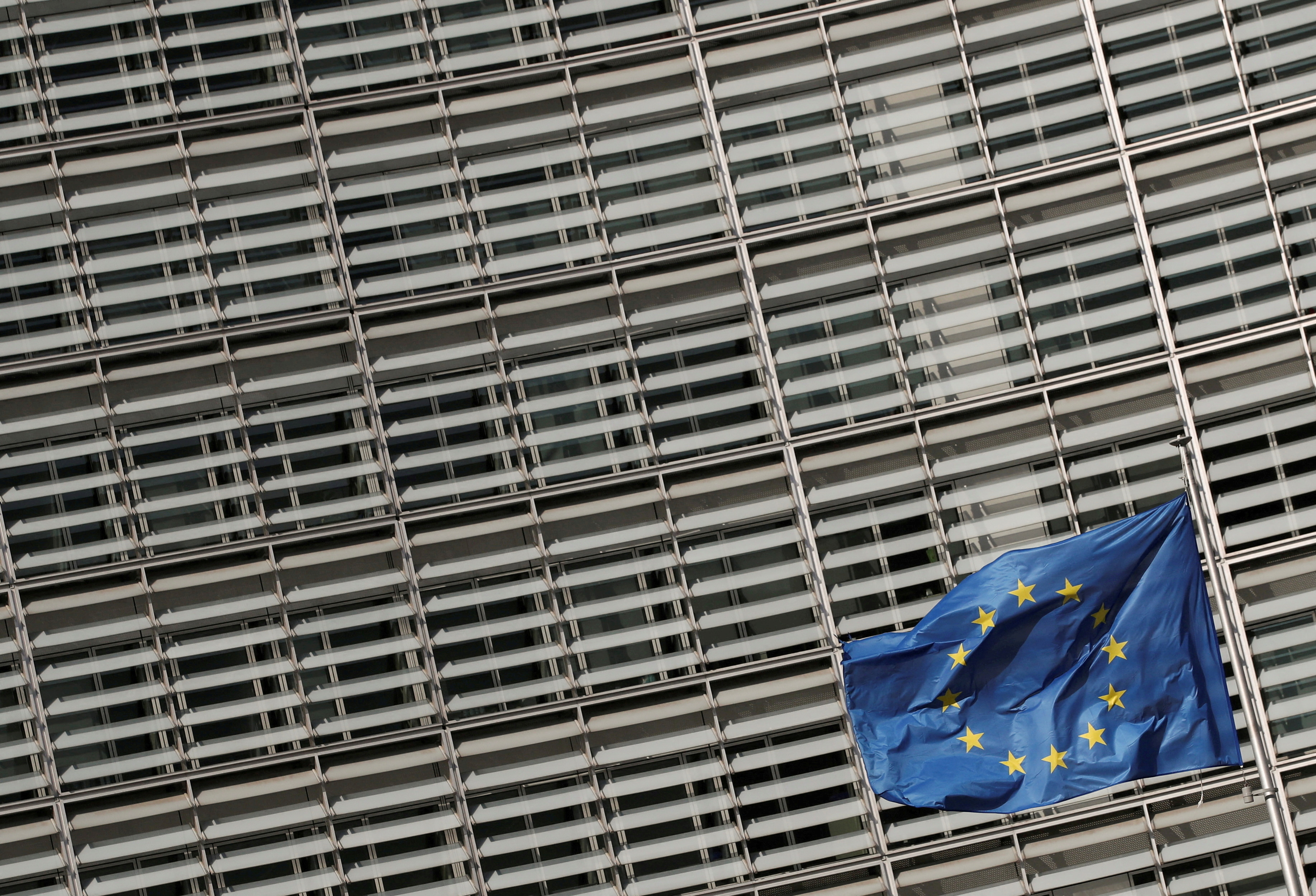 A European Union flag flutters outside the European Commission headquarters in Brussels