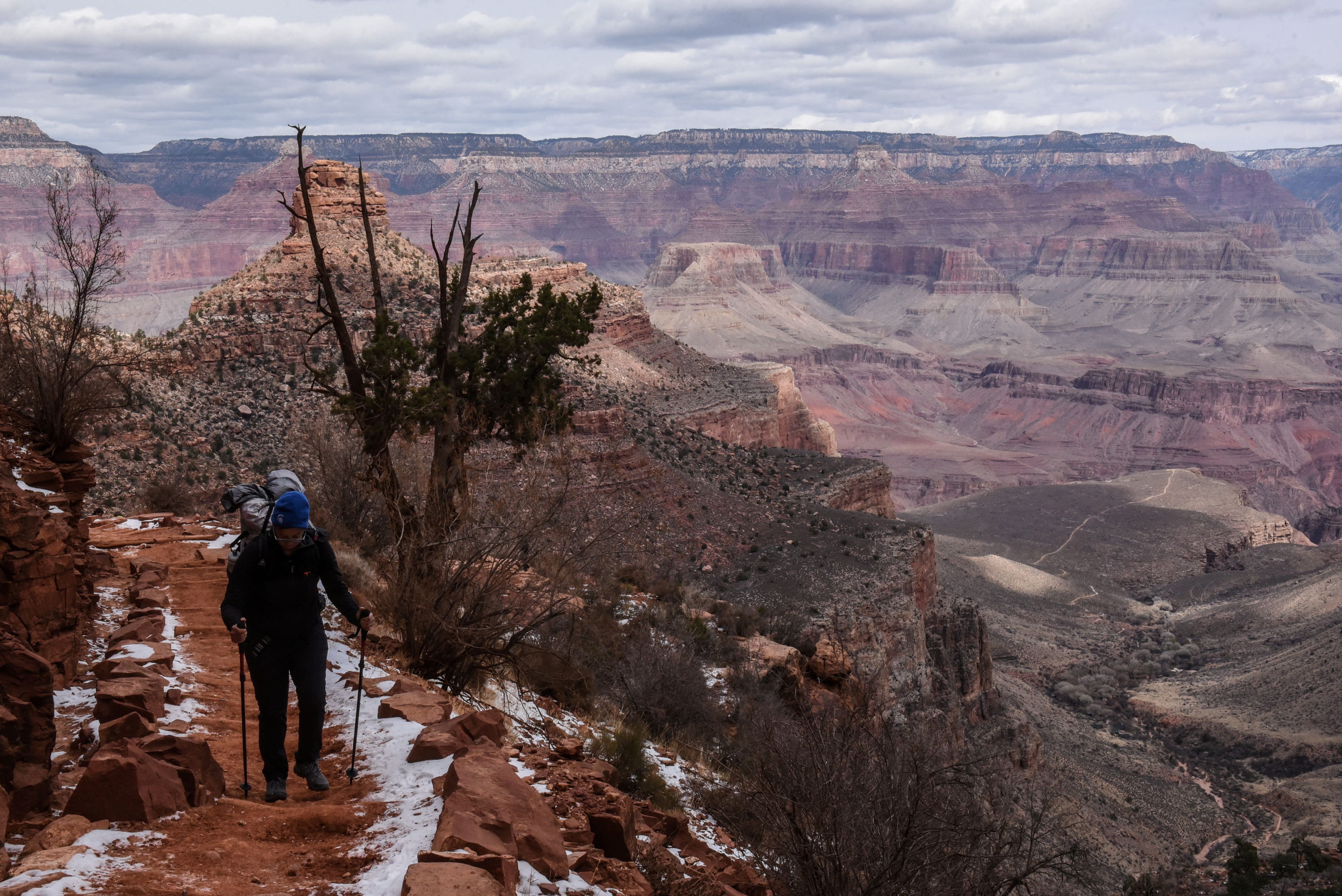 A person hikes on the Bright Angel Trail in the Grand Canyon near Grand Canyon Village