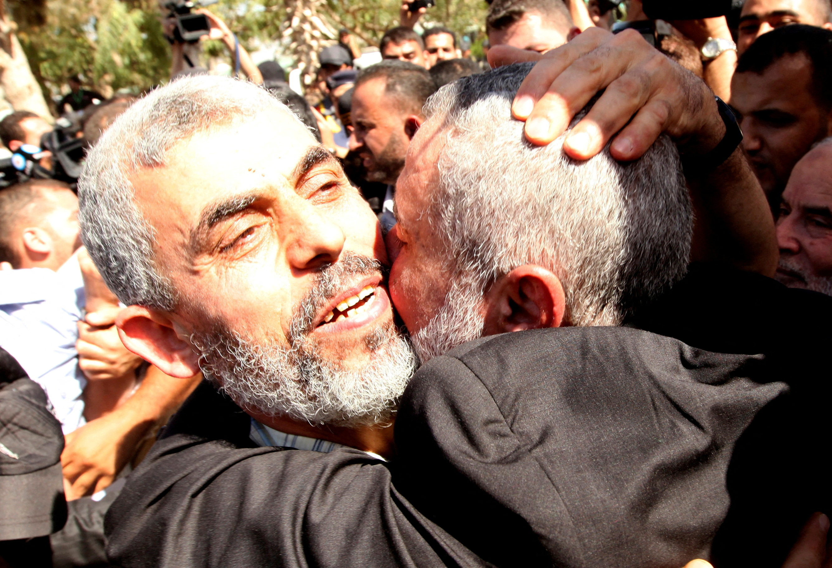 Freed Hamas top security strategist Al-Sinwar is hugged by senior Hamas leader Haniyeh upon his arrival at the Rafah crossing in the Gaza Strip