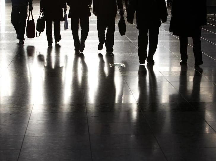People walk along a corridor of a exhibition hall in Tokyo