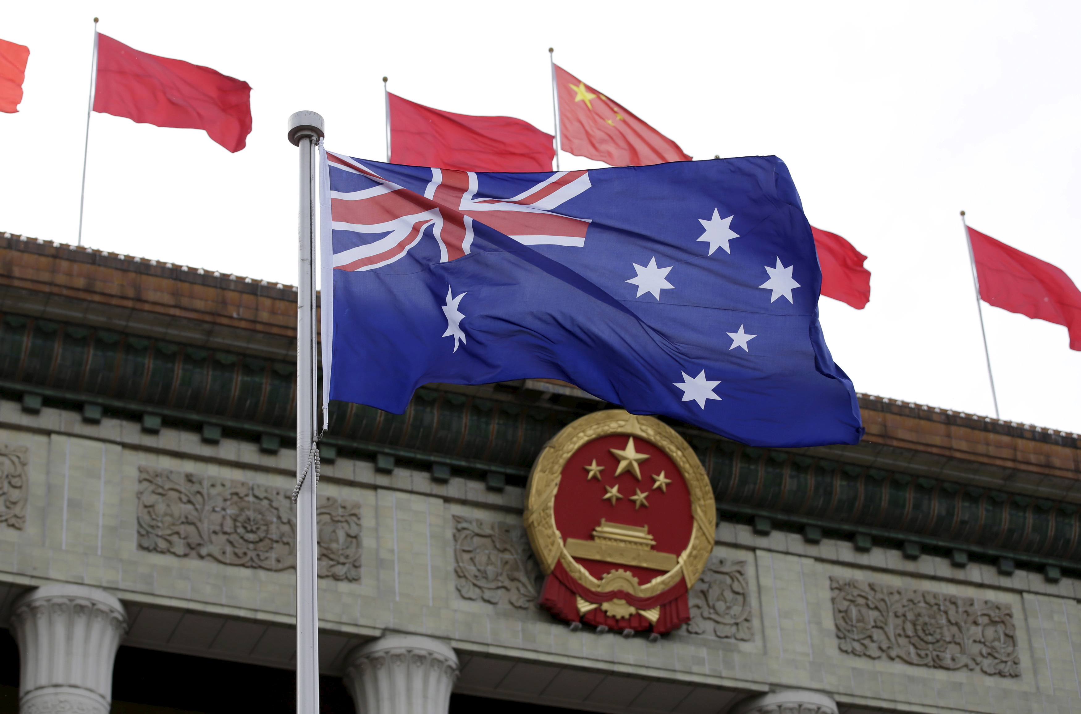 Australian flag waves in front of the Great Hall of the People in Beijing