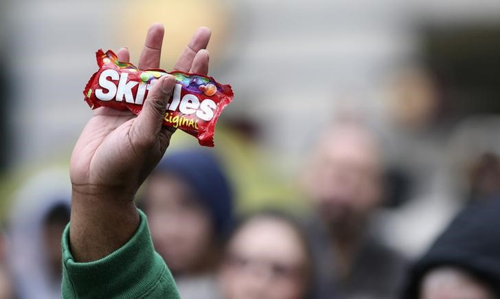 A demonstrator holds a bag of Skittles during the Seattle Unite 1000 Hoodies rally for Trayvon Martin at Westlake Park in Seattle