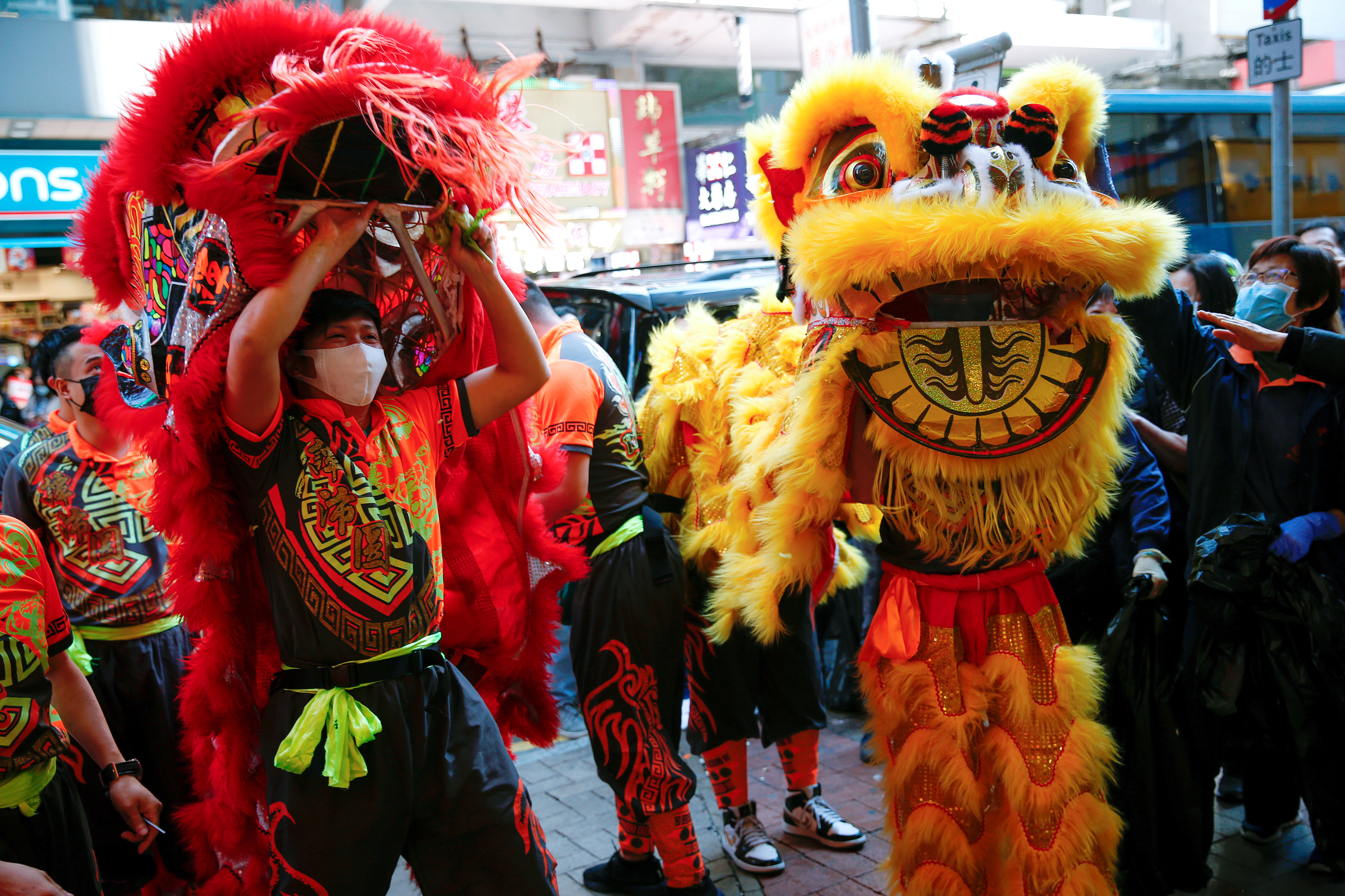 Performers wear masks to prevent an outbreak of a coronavirus as they perform a traditional Chinese lion dance to mark the Chinese Lunar New Year, in Hong Kong