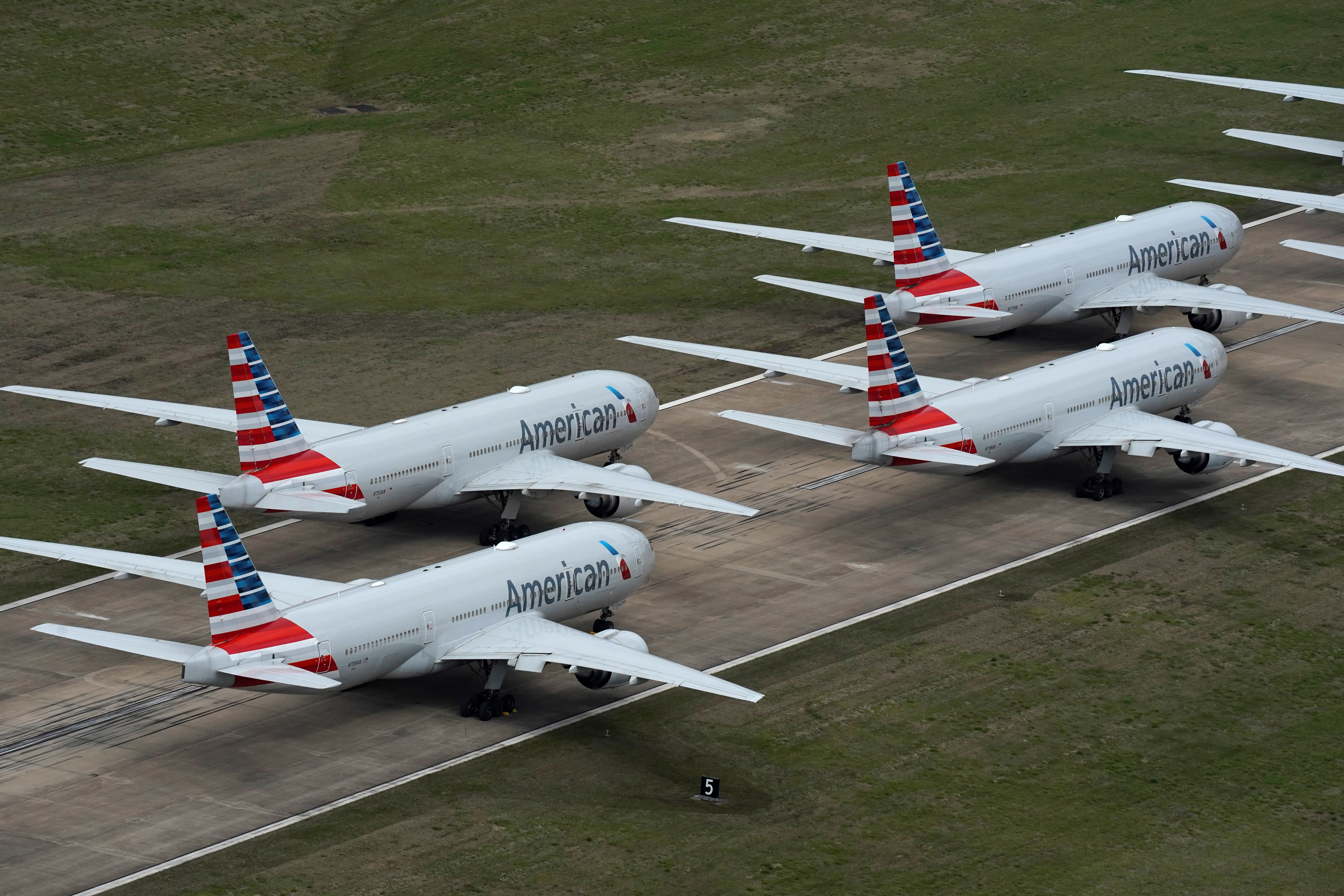 American Airlines passenger planes crowd a runway where they are parked due to flight reductions to slow the spread of coronavirus disease (COVID-19), at Tulsa International Airport in Tulsa