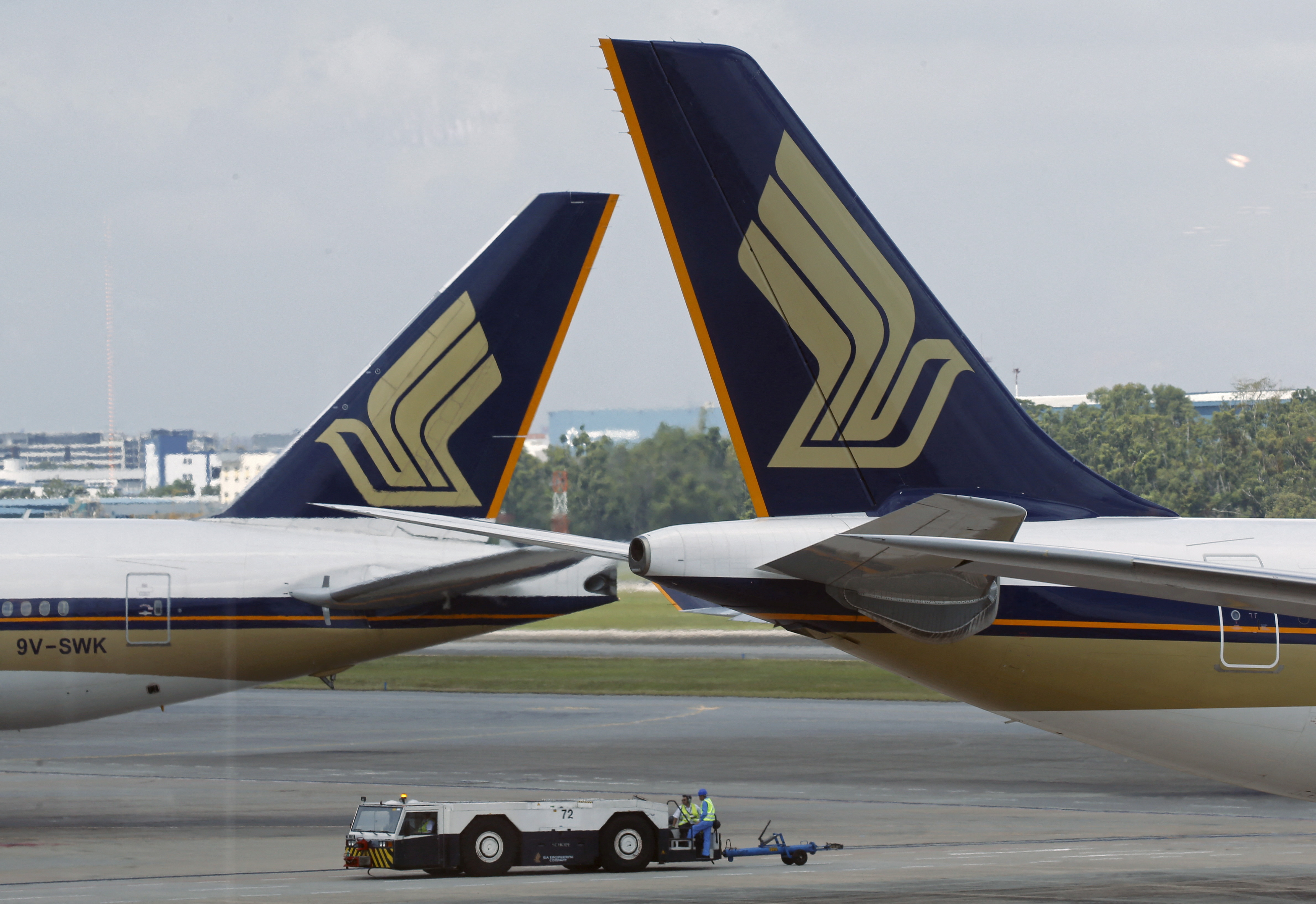 Singapore Airlines (SIA) planes sit on the tarmac in Singapore's Changi Airport