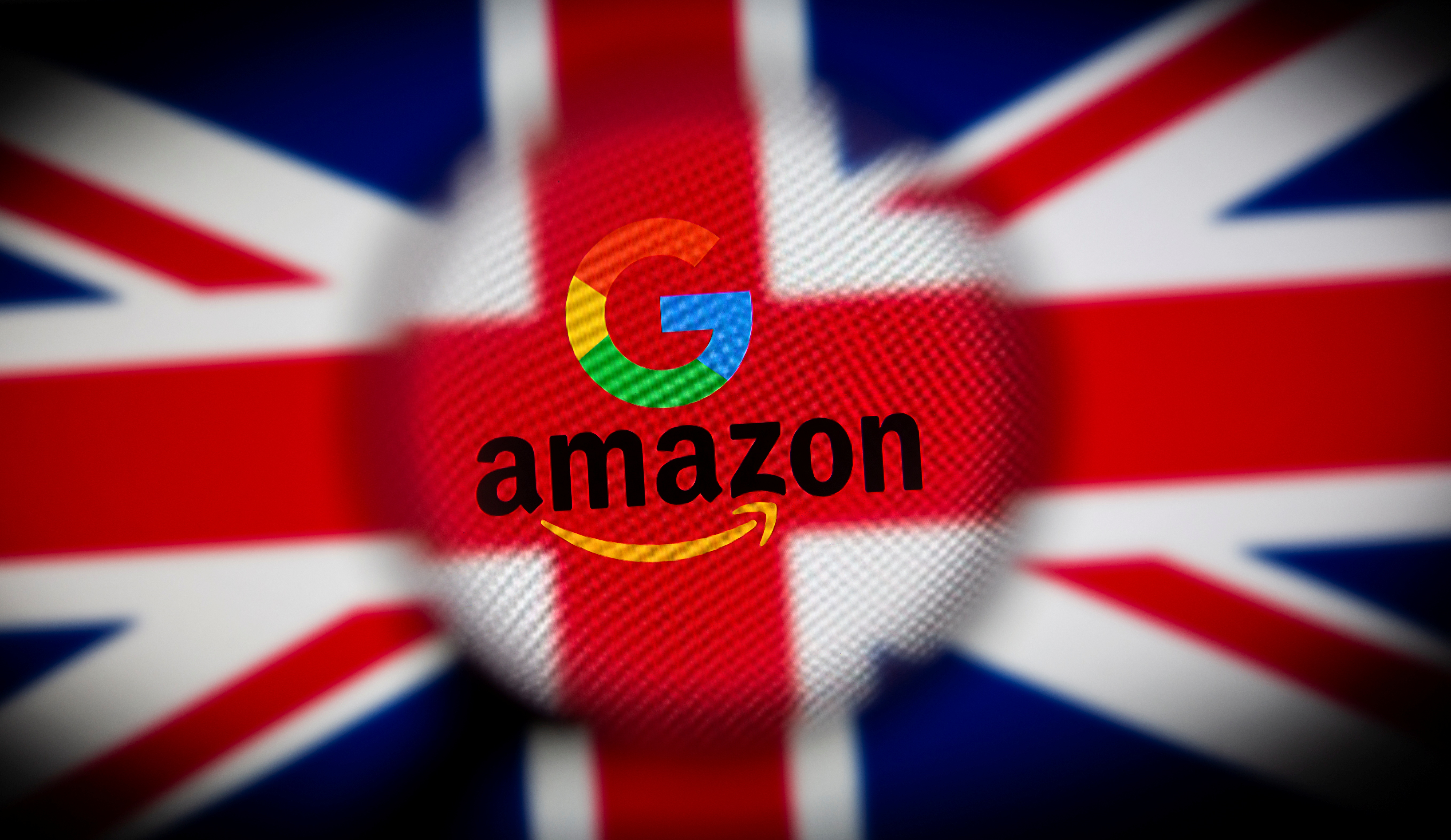 UK flag, Google and Amazon logos are seen displayed through magnifier in this illustration picture
