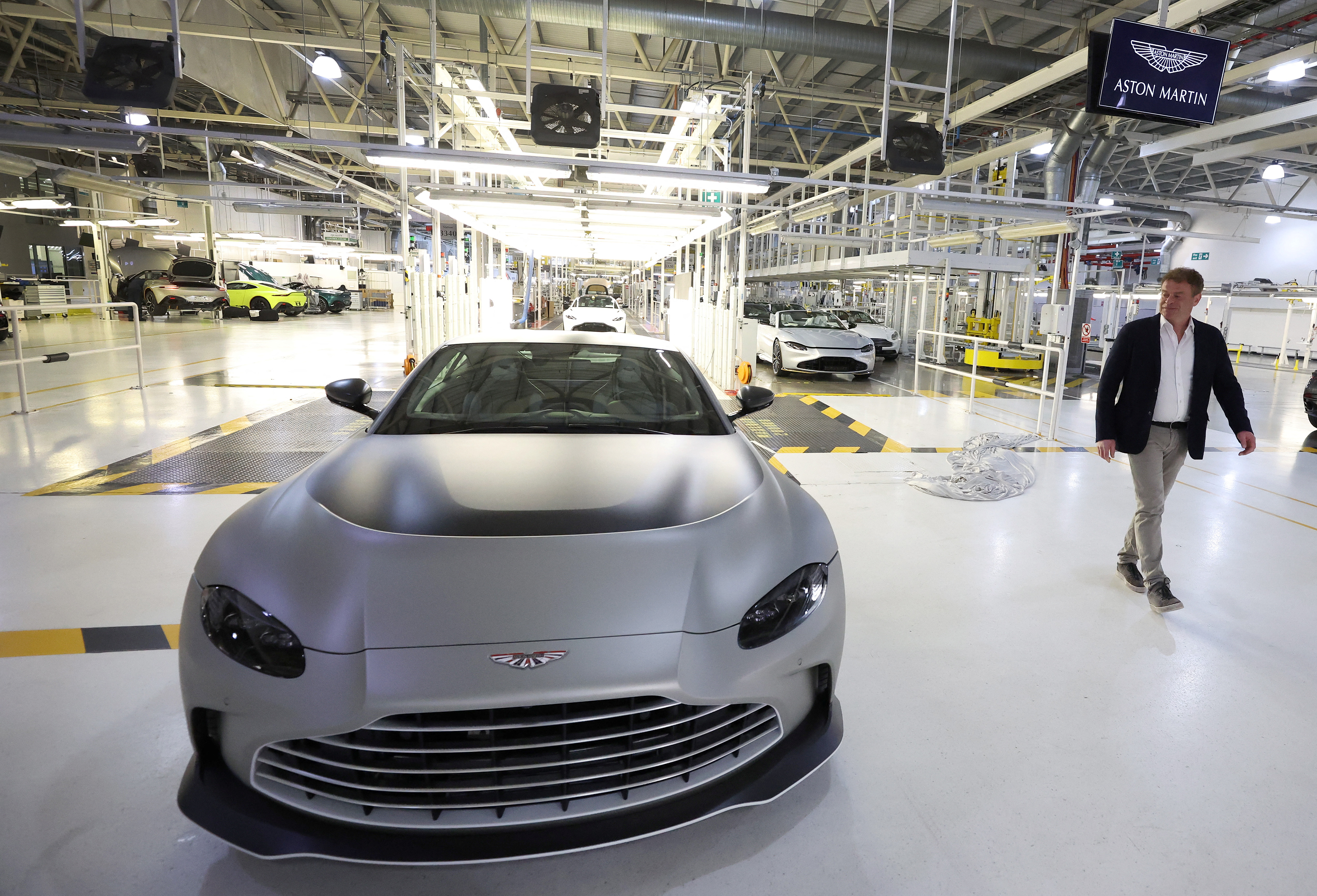 Aston Martin CEO Tobias Moers walks past the newly unveiled V12 Vantage car at the company’s factory in Gaydon