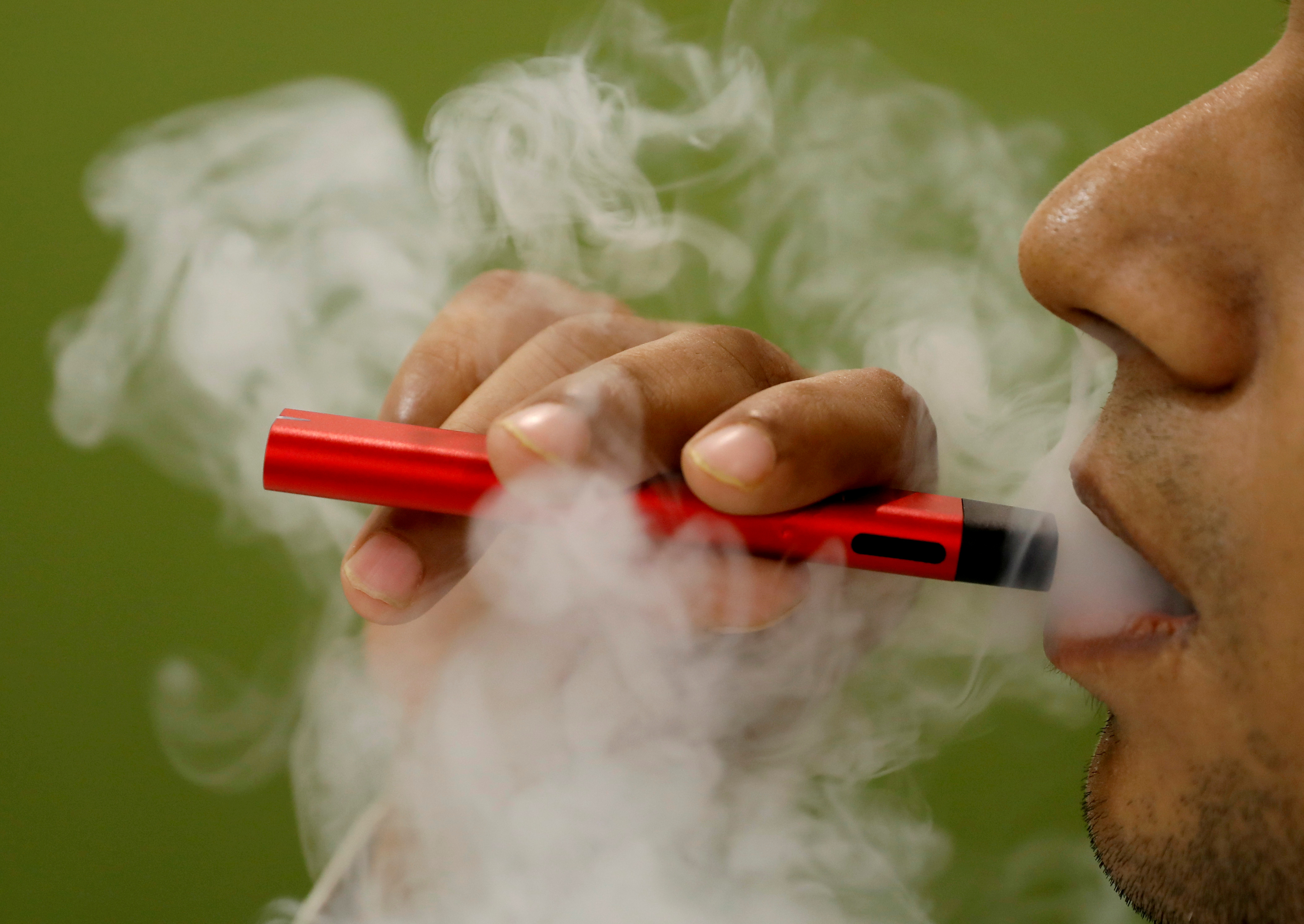 FILE PHOTO: A man uses a vape device in this illustration picture