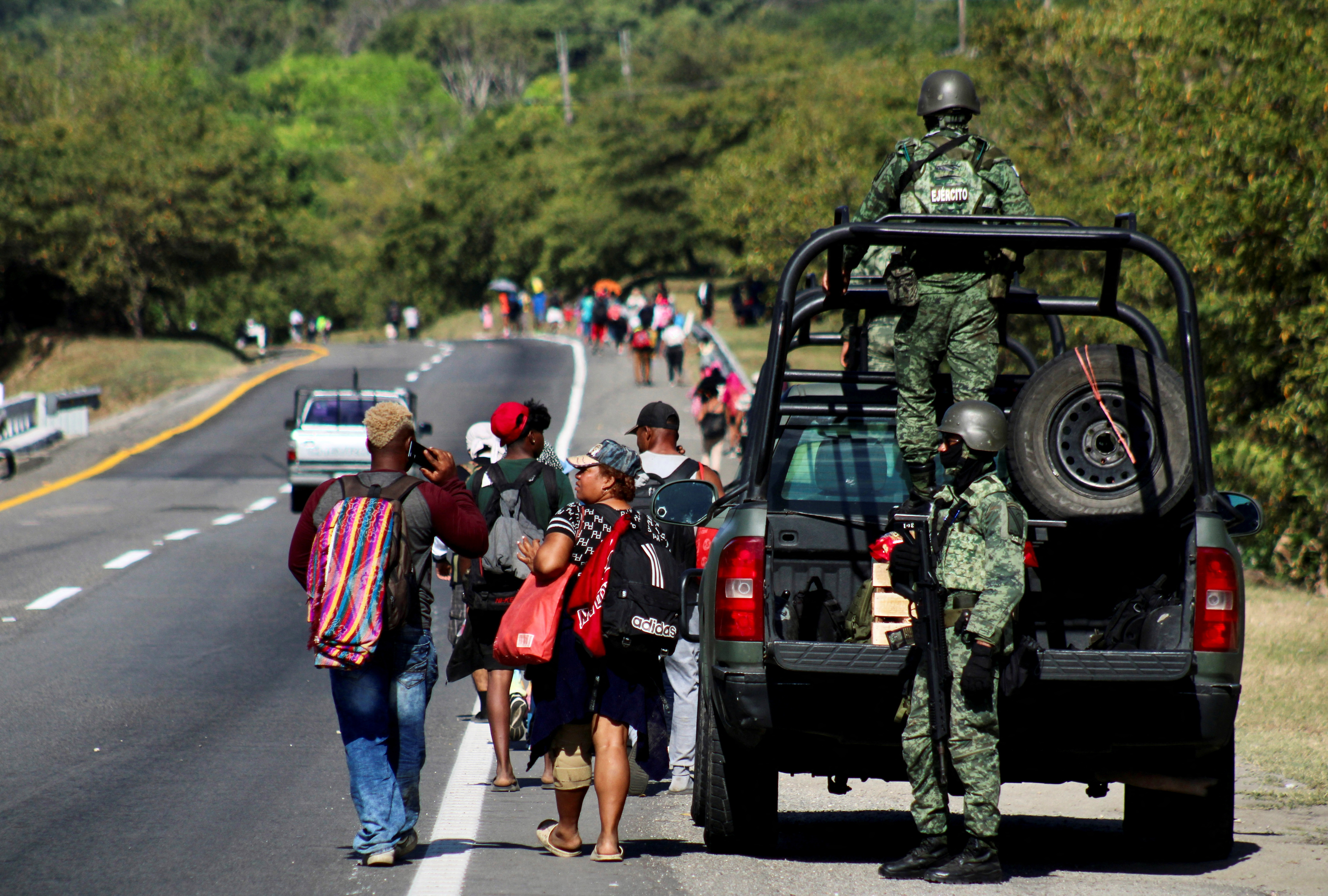 Migrants walk in a caravan to reach the U.S. border through Mexico, in Escuintla