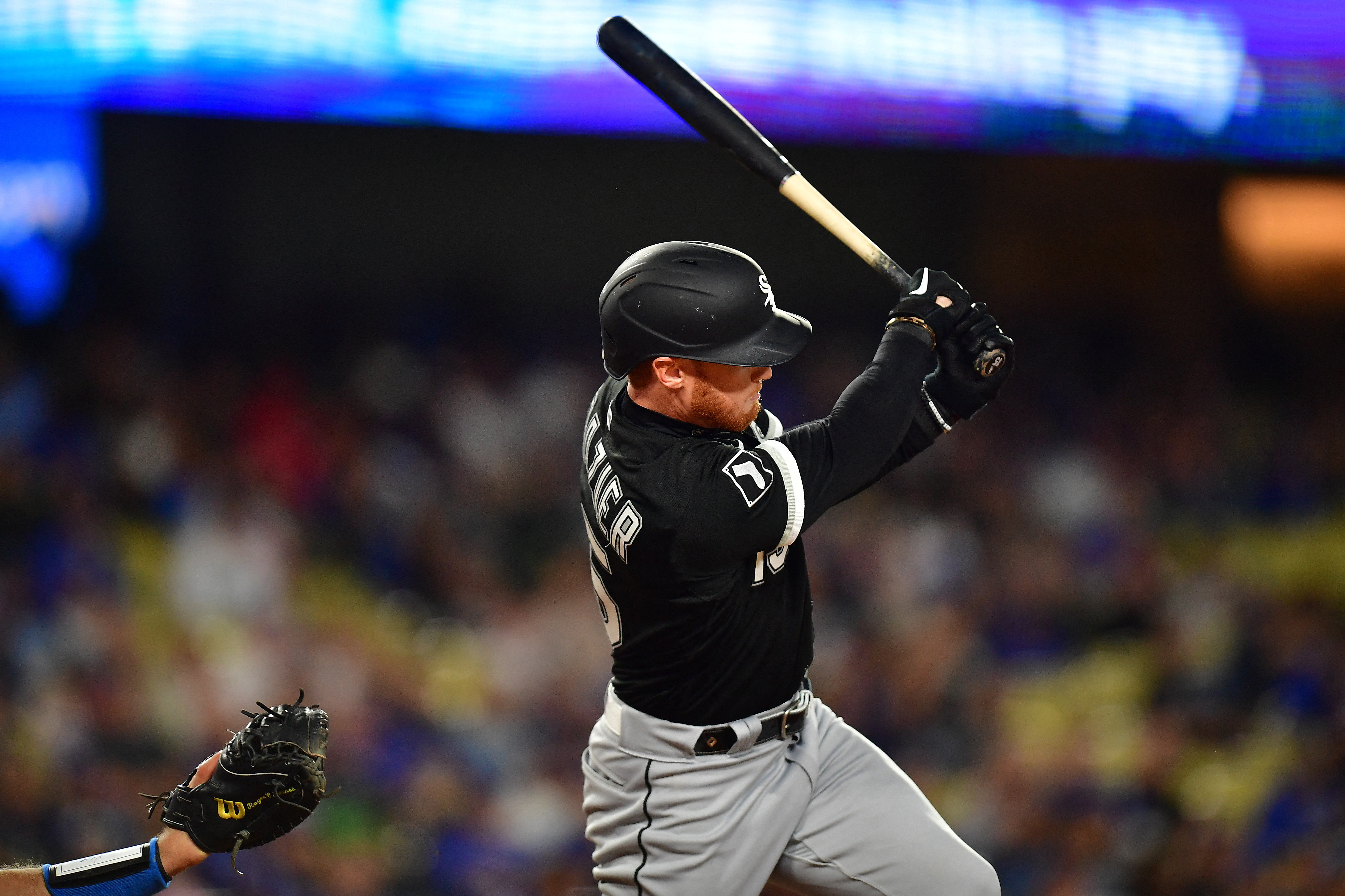 Chicago White Sox's Jake Burger swings at a pitch in a baseball