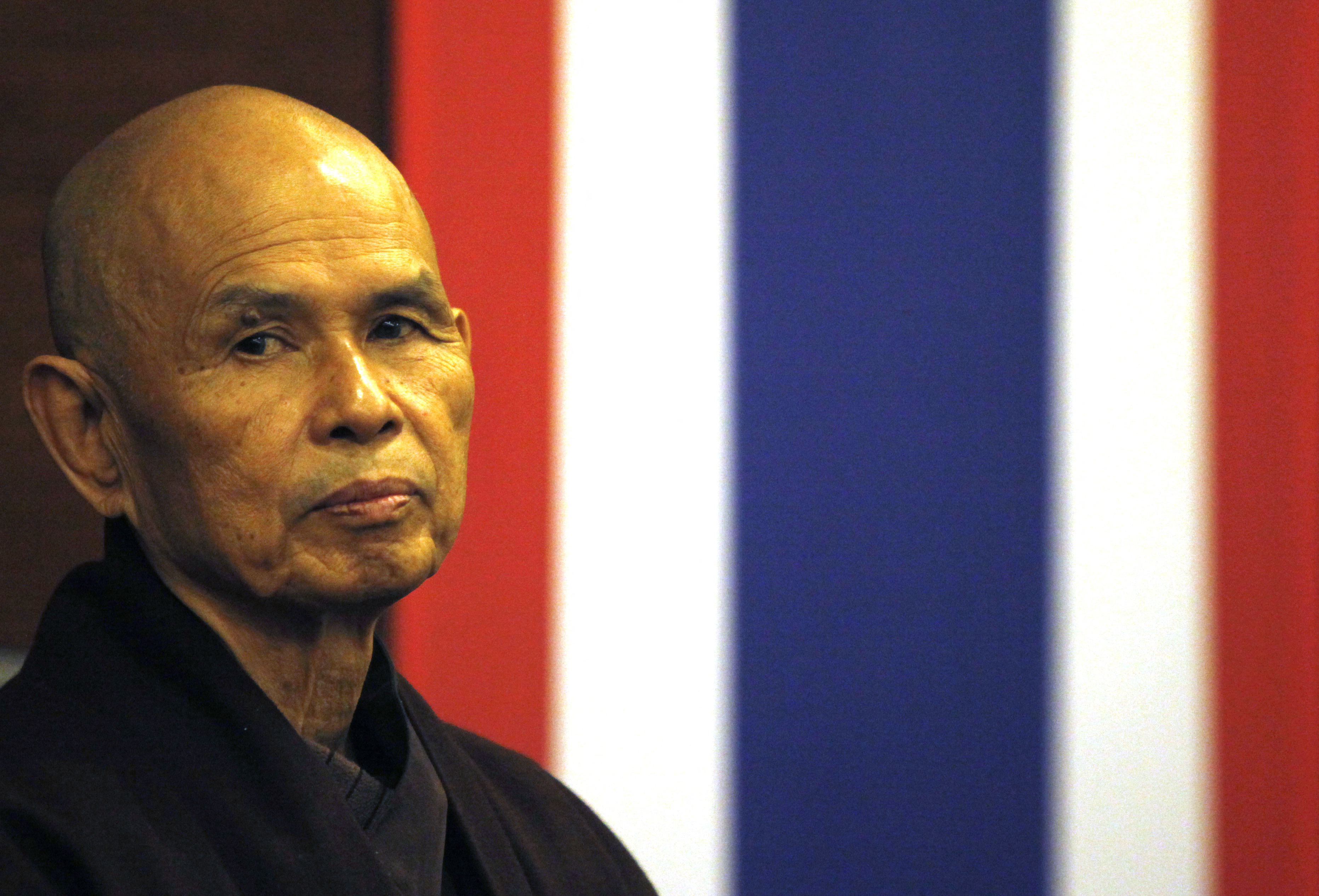 French-based Buddhist zen master Thich Nhat Hanh gestures during his arrival at Suvarnabhumi airport in Bangkok