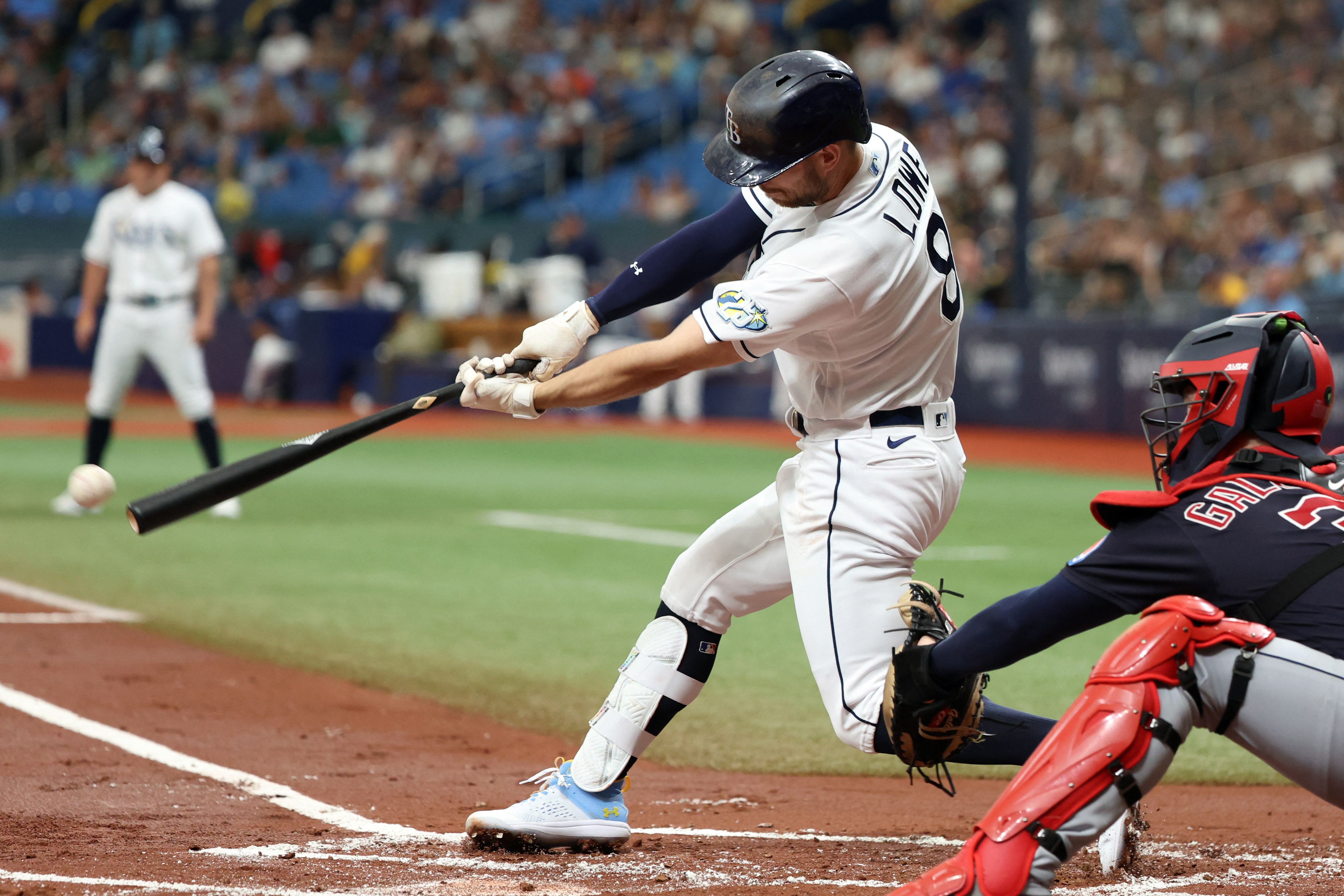 Cleveland Guardians' Kole Calhoun scores against the Tampa Bay