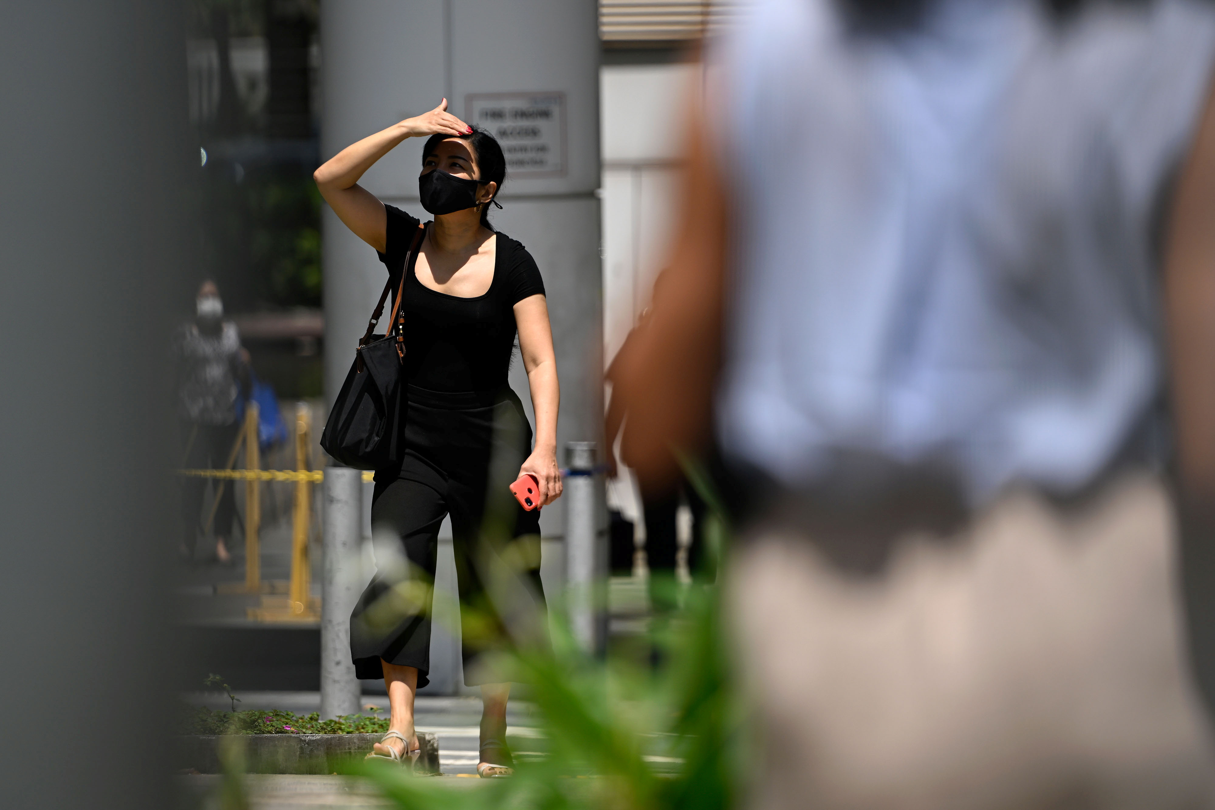 A lady strolls along the street amid the coronavirus disease (COVID-19) Omicron wave in Singapore