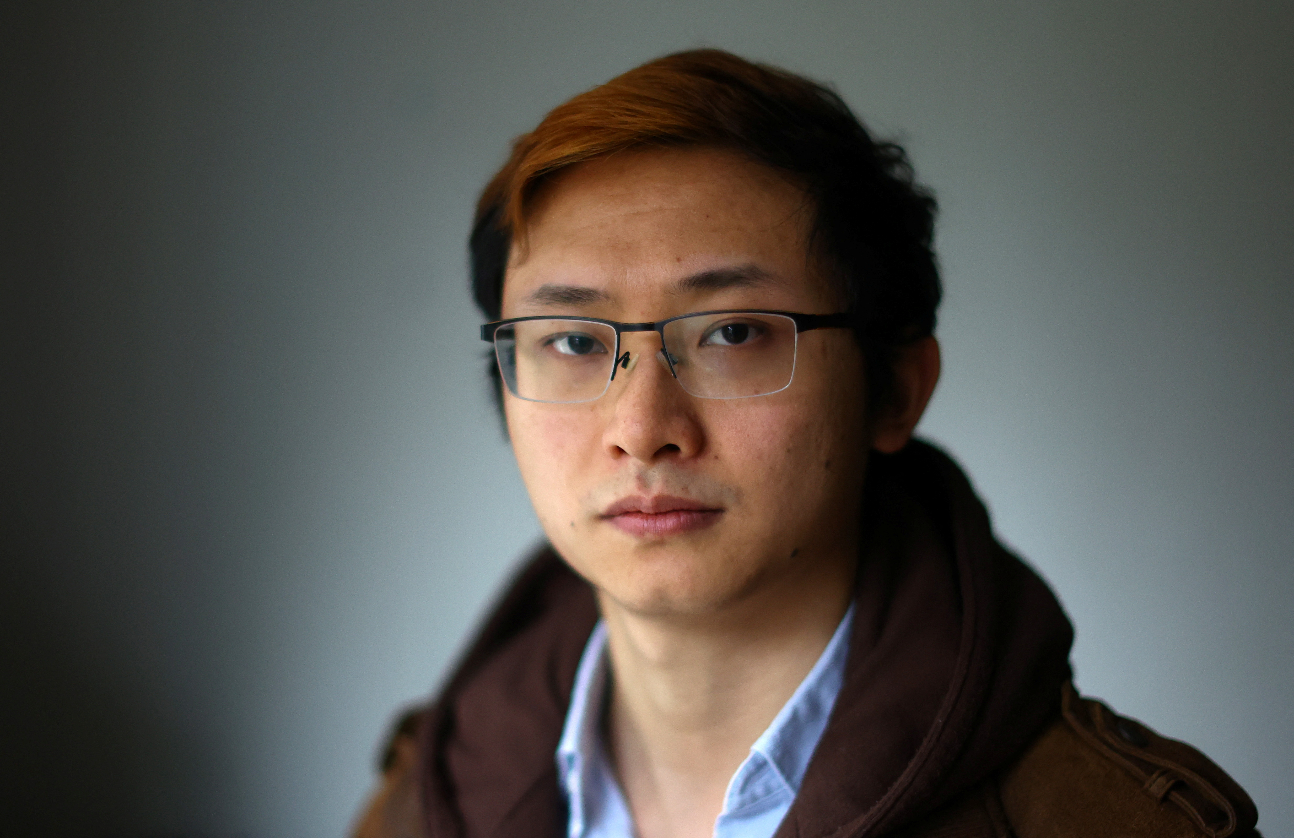 Junior Doctor Poh Wang poses for a photograph at his home in London
