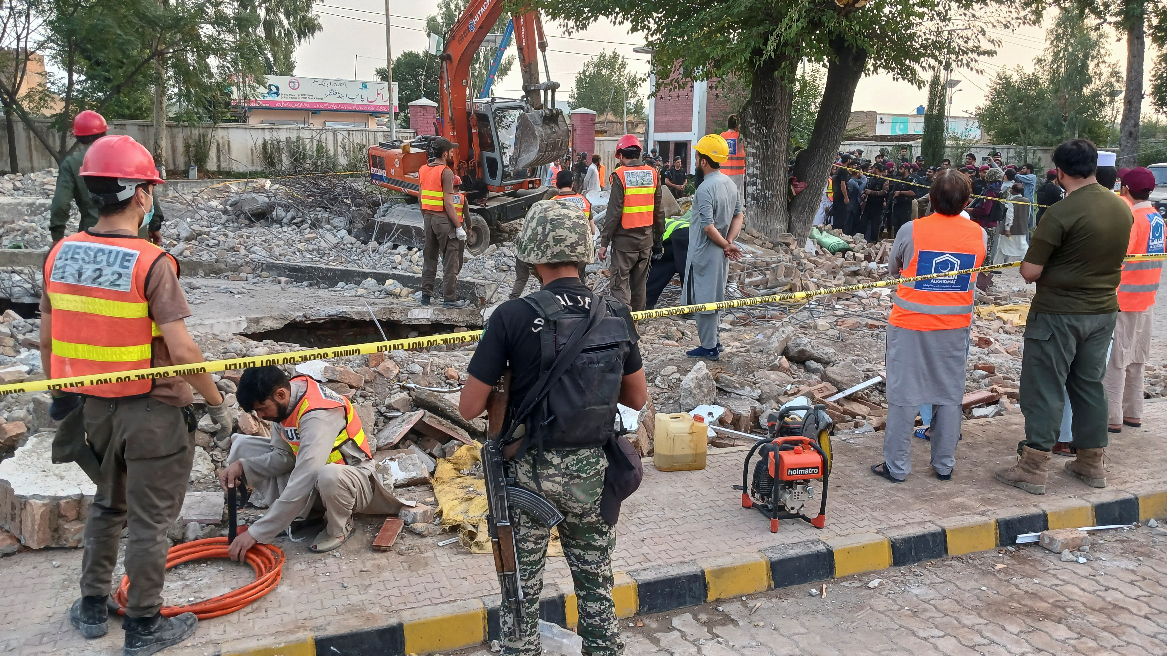 Rescue workers clear the rubble from a damaged mosque, after a suicide blast in Hangu