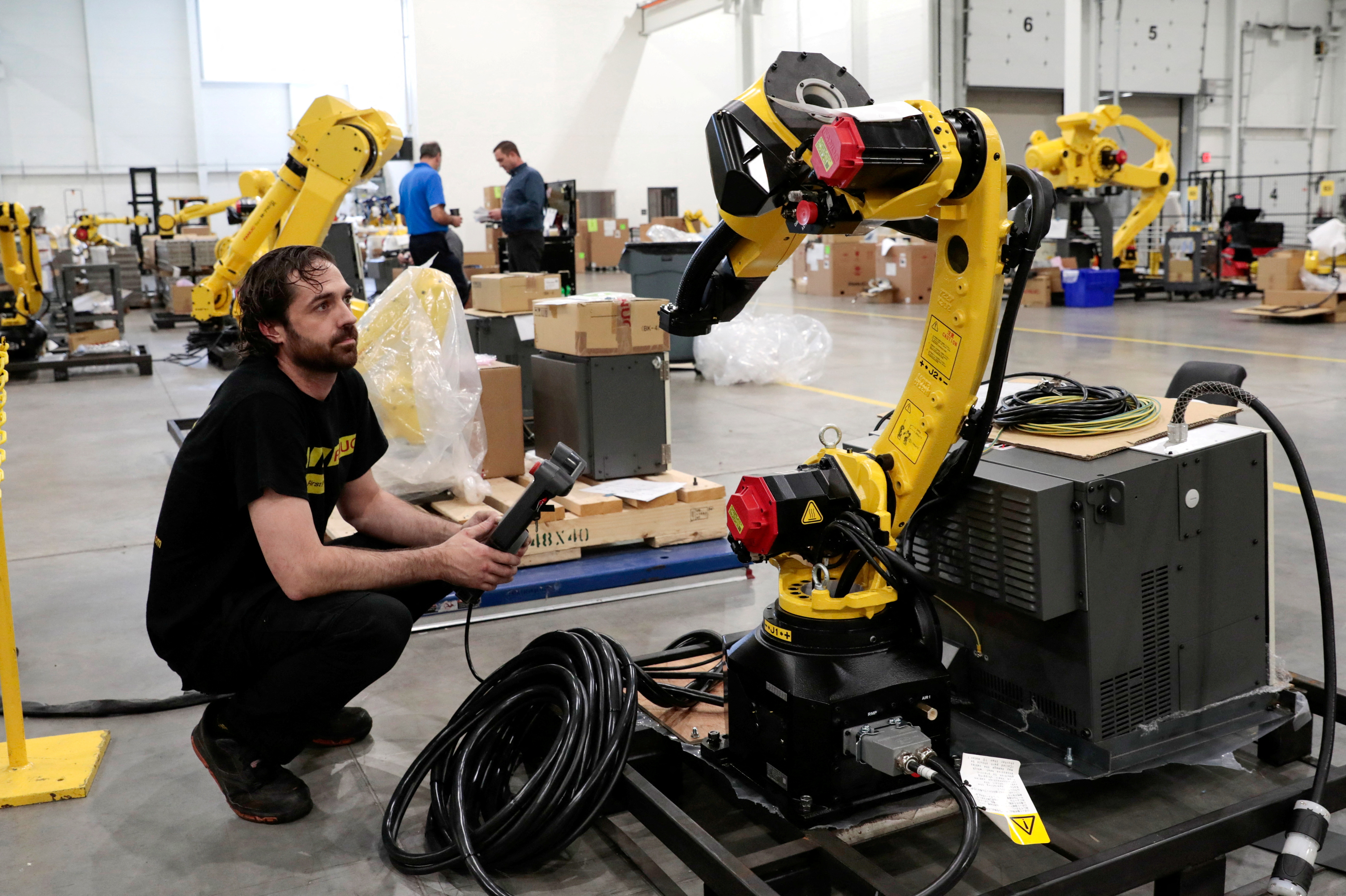 An inventory of manufacturing robots waiting to be shipped to customers are seen in a FANUC American facility