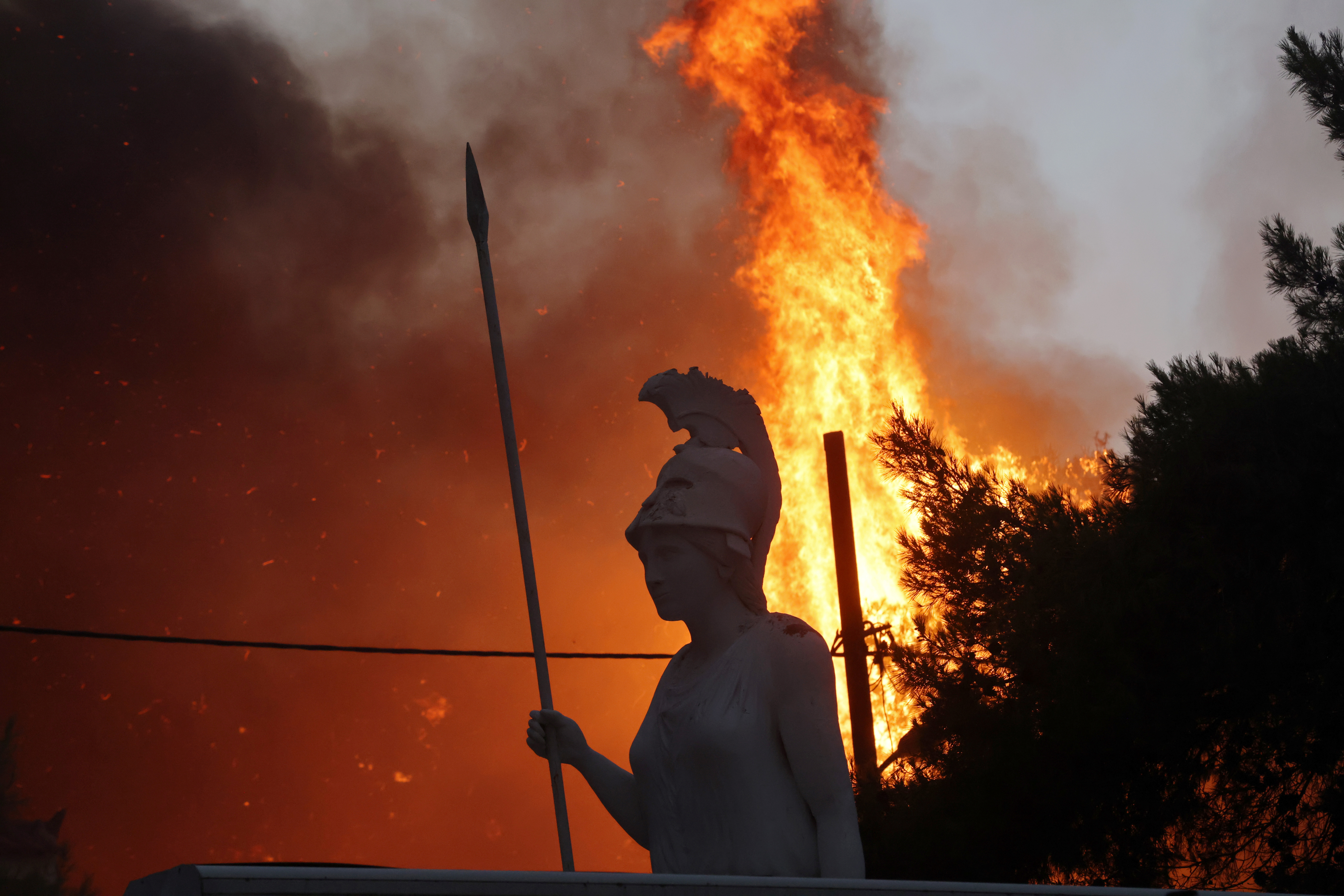 Athens suburbs brace for night inferno as blaze burns homes | Reuters