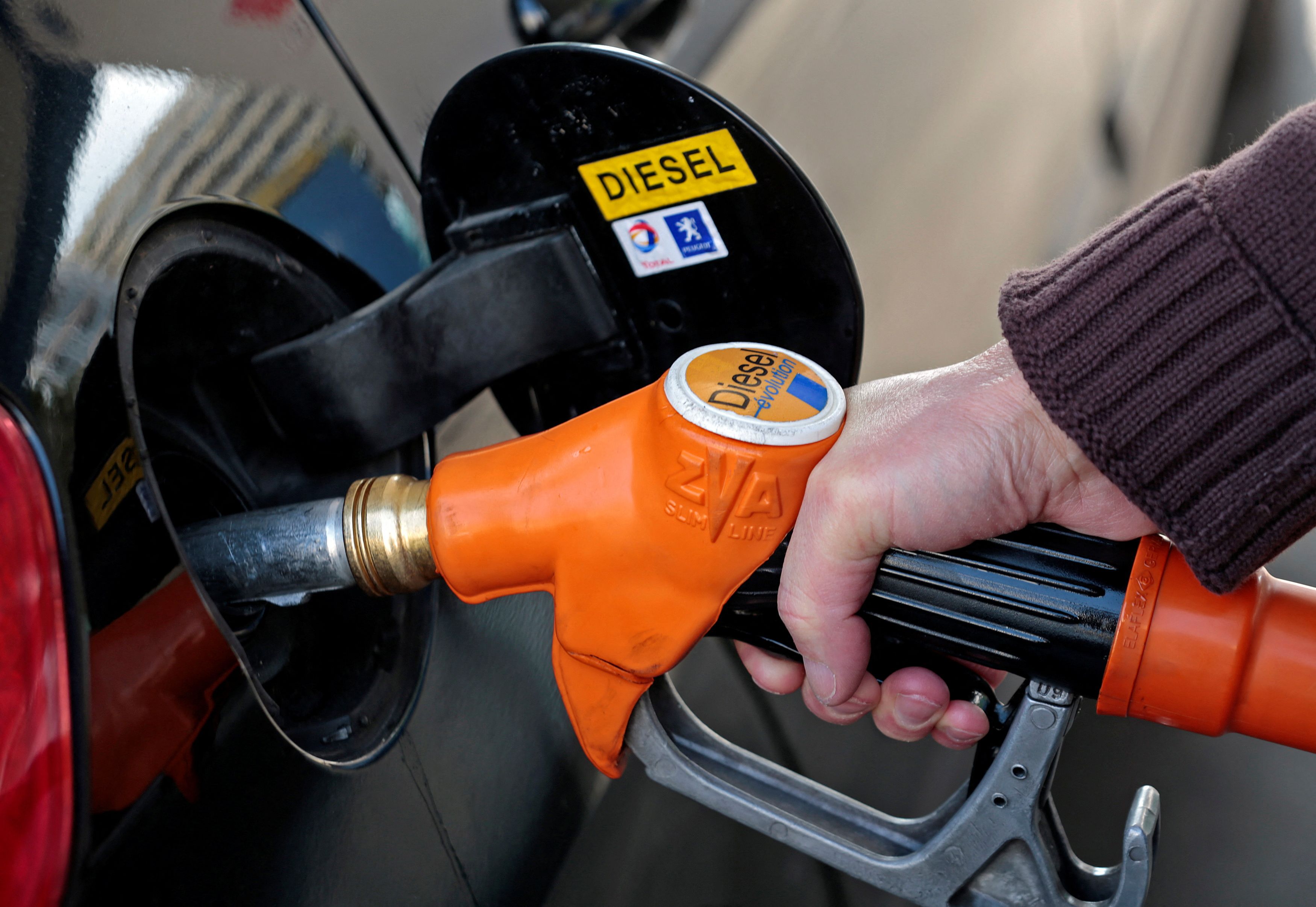 A customer fills-up his car with diesel at a gas station in Nice