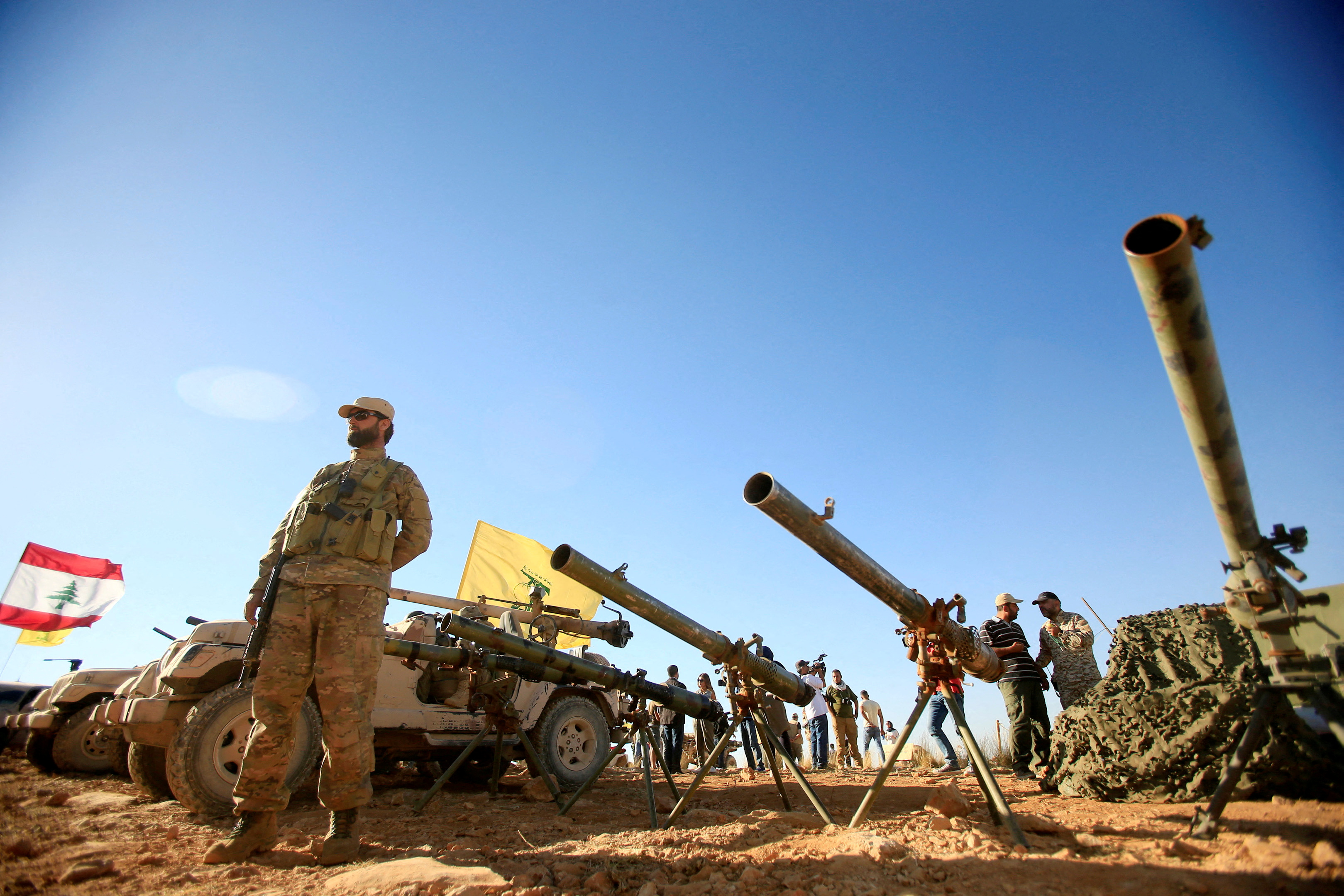 A Hezbollah fighter stands in front of anti-tank artillery at Juroud Arsal