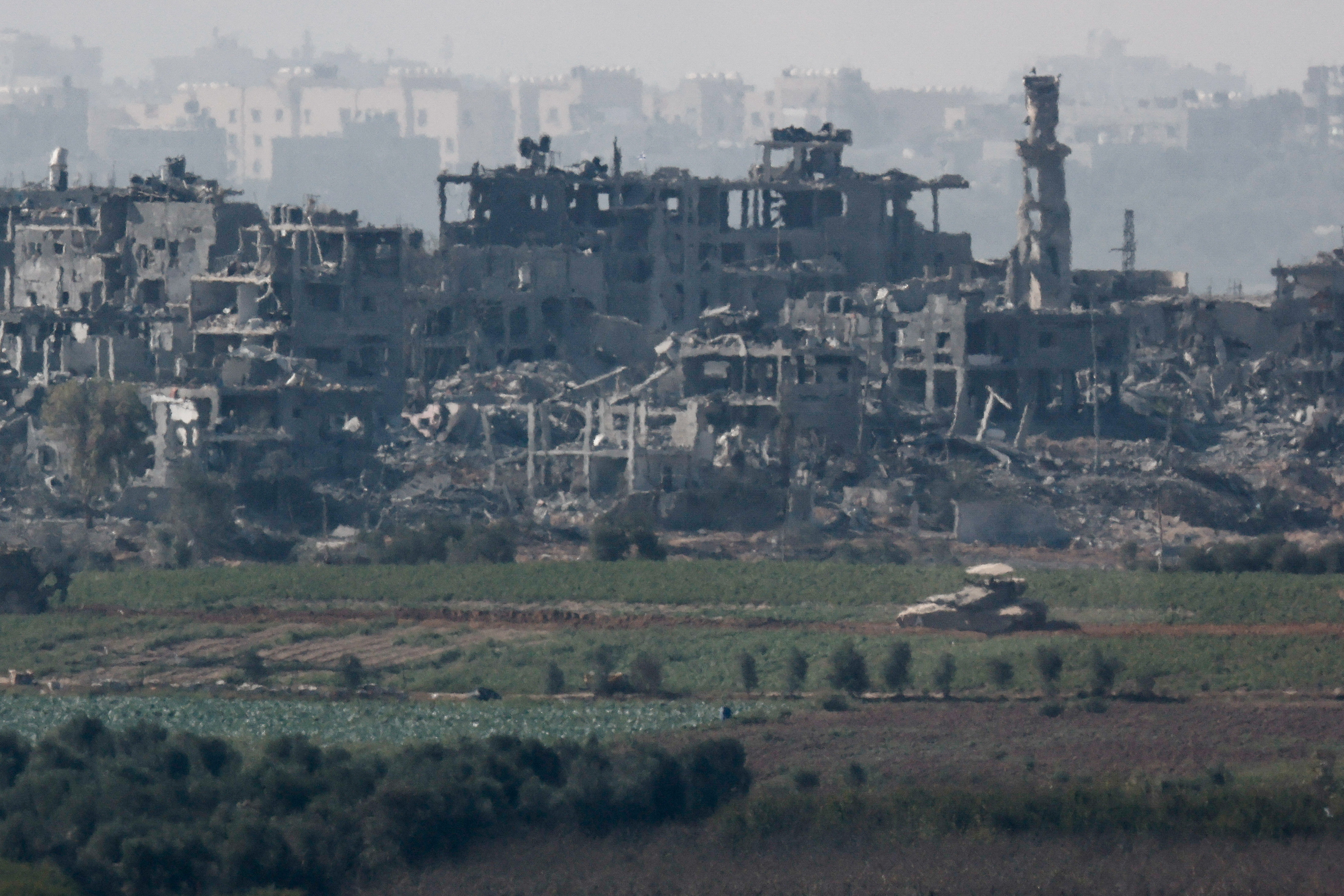 A tank manoeuvres inside Gaza Strip, as seen from the city of Sderot