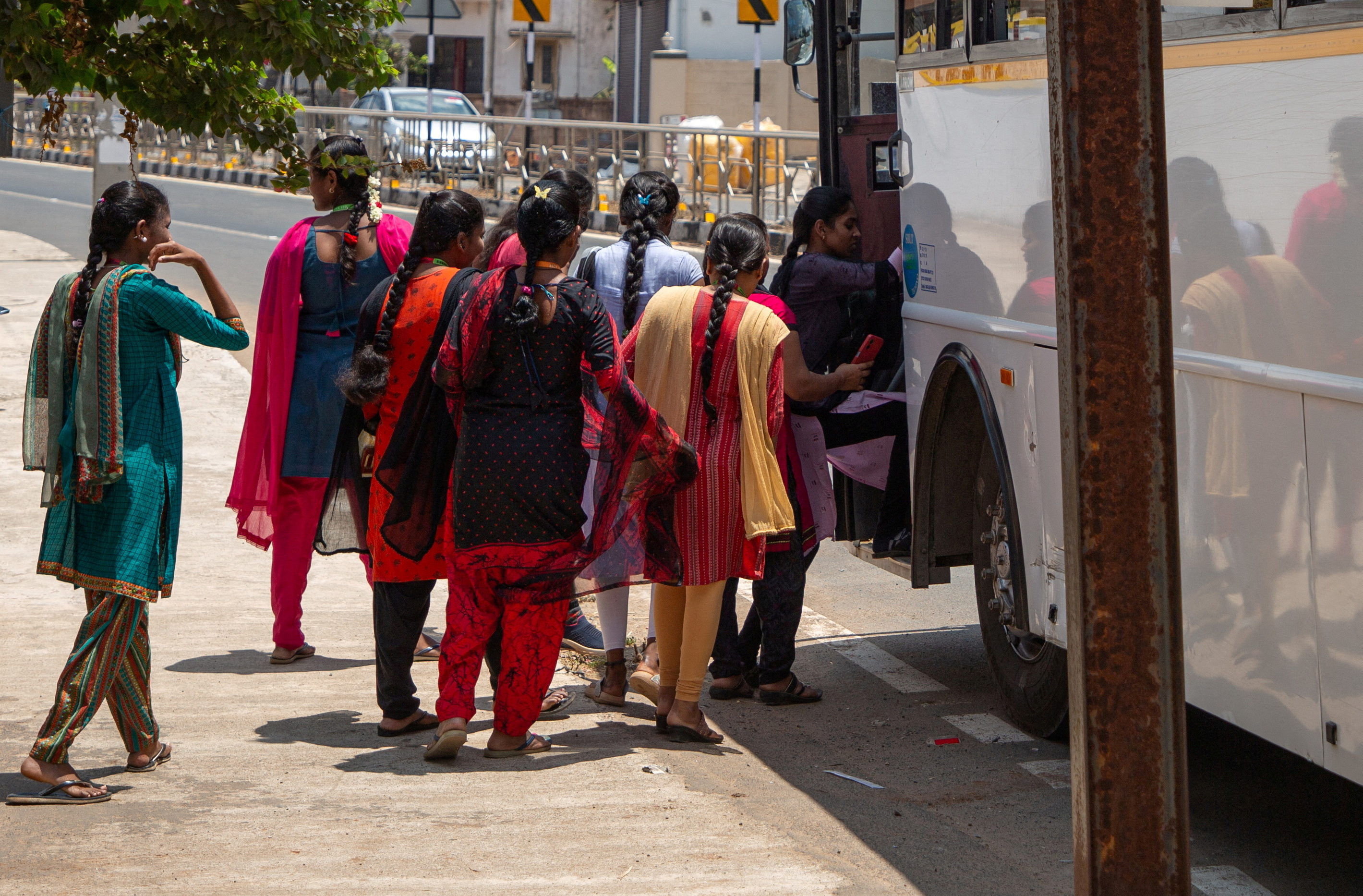 Women board a Foxconn factory bus near the village of Molachur