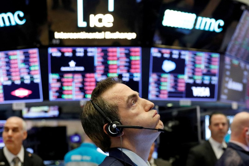 A trader works on the floor of the New York Stock Exchange shortly before the closing bell as the market takes a significant dip in New York