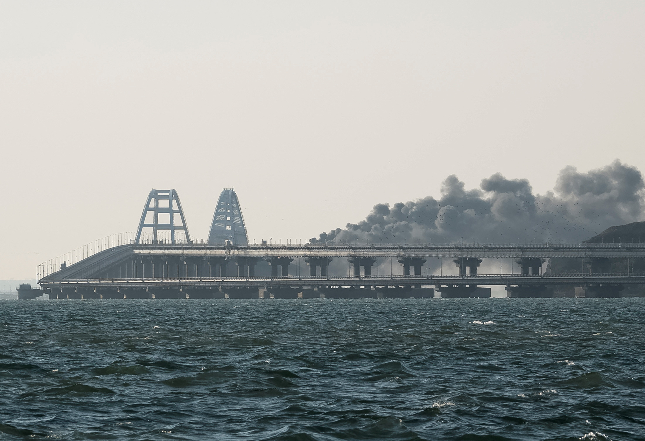 Smoke rises from fire on the Kerch bridge in the Kerch Strait, Crimea