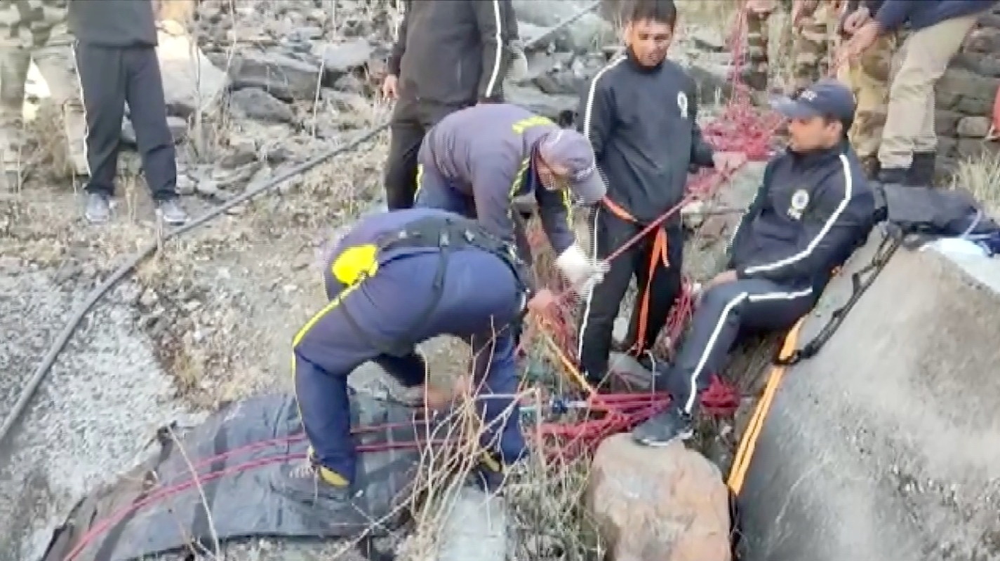 Rescue personnel adjust ropes during rescue operation after a glacier burst, in this still frame taken from video dated February 7, 2021, in Chamoli, Uttarakhand, India