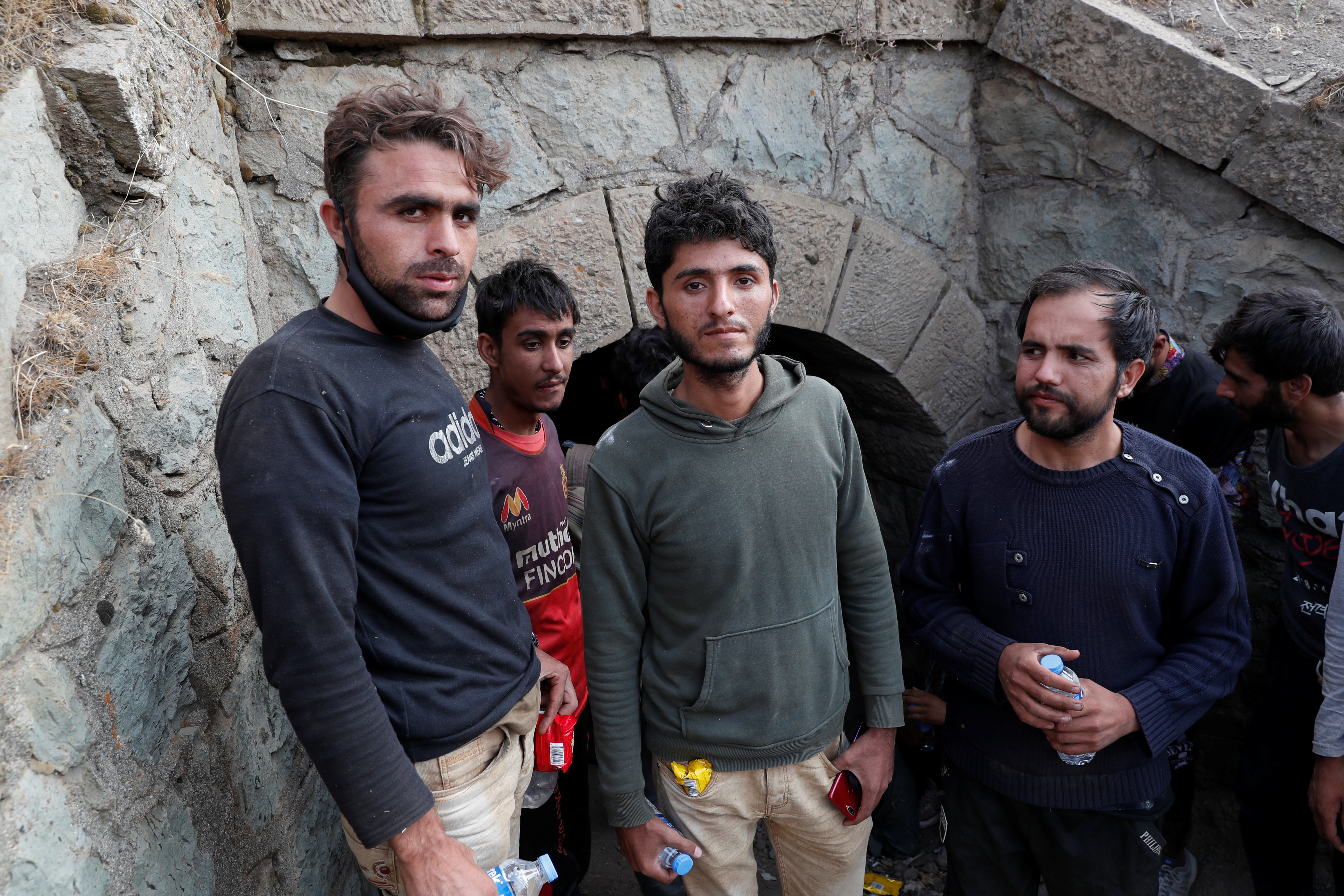 Muhammad Ali, an Afghan migrant from Khost who planned to found his own cryptocurrency mining business, center, and the other migrants hide from security forces after crossing illegally into Turkey from Iran, near Tatvan in Bitlis province, Turkey August 23, 2021. REUTERS/Murad Sezer