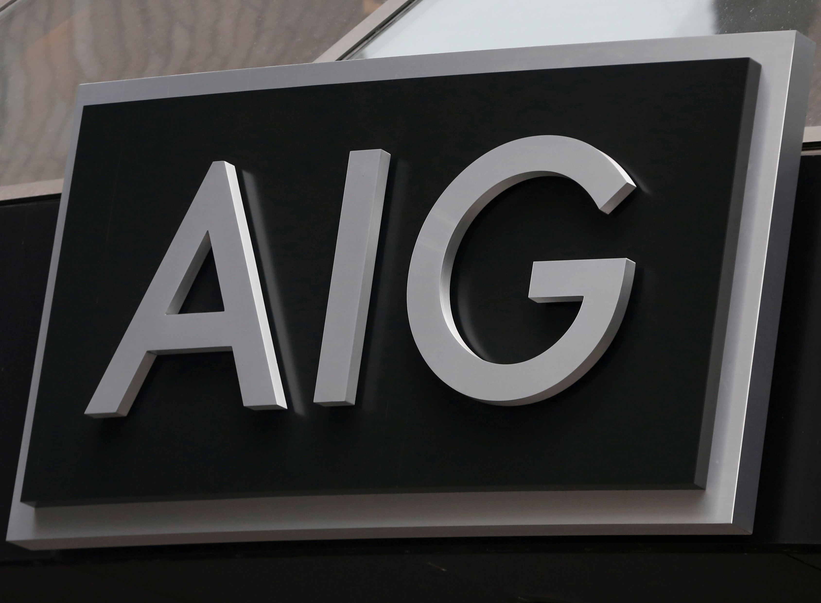 FILE PHOTO: A sign is displayed over the entrance to the AIG headquarters offices in New York's financial district