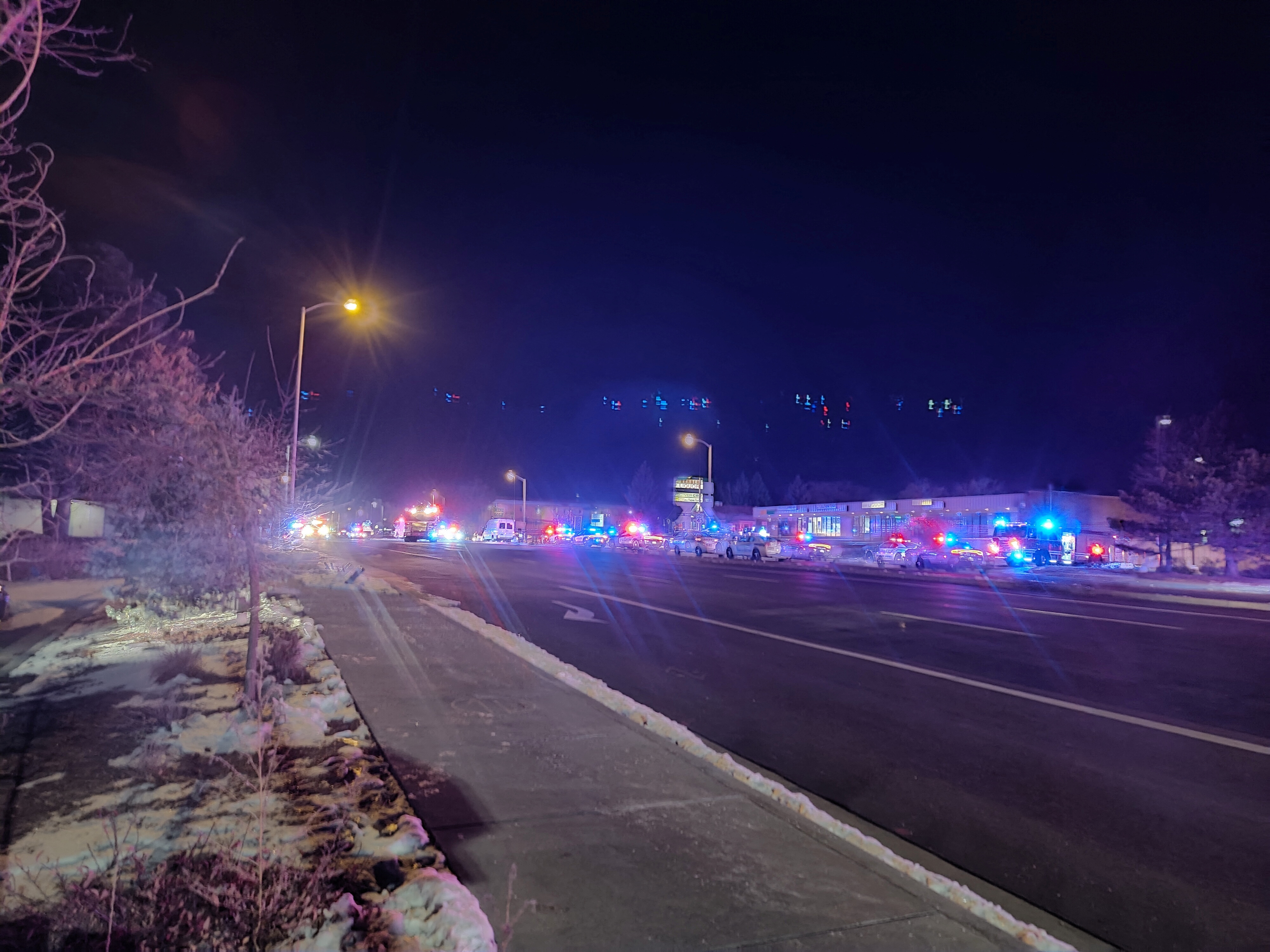 A view of various security and emergency vehicles parked on a street, after a shooting, in Colorado Springs