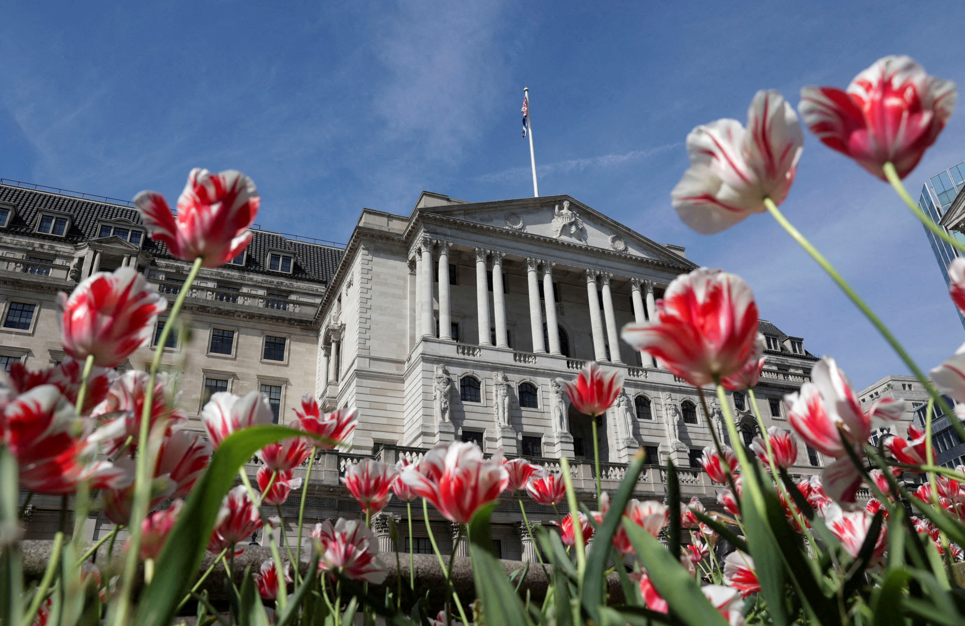 The Bank of England building is seen surrounded by flowers in London