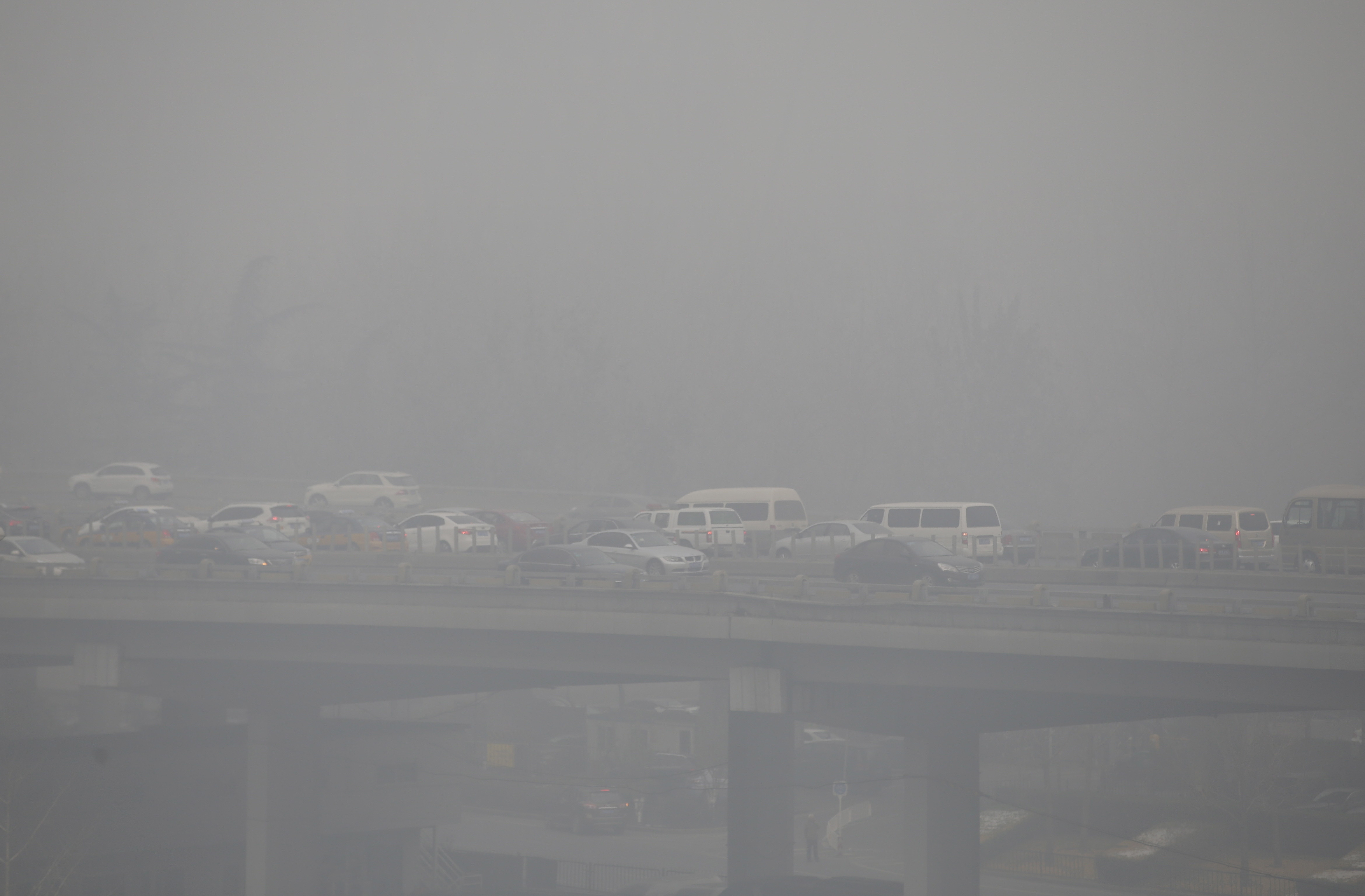 Vehicles drive amid heavy smog in Beijing