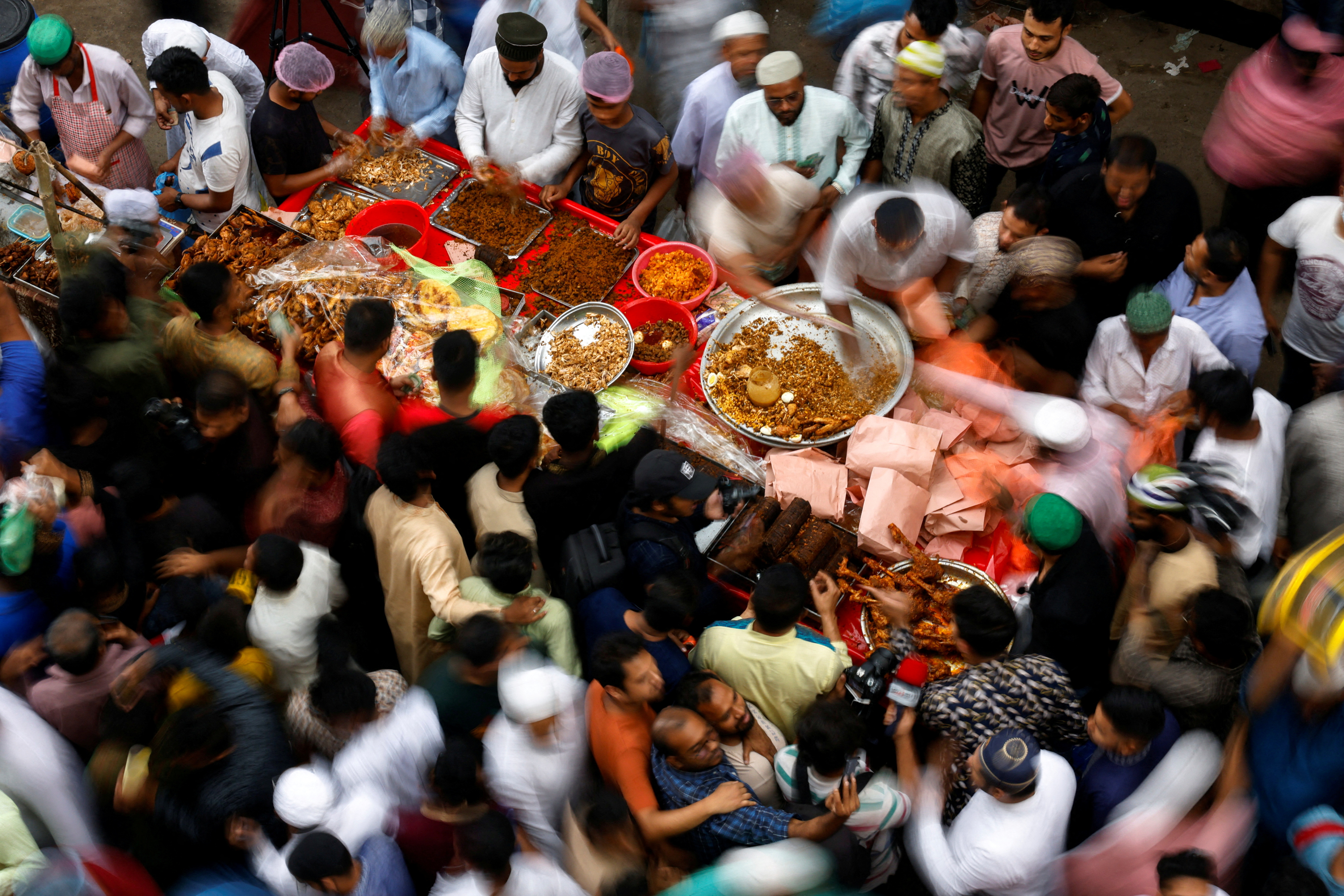 Muslims gather to buy food, on the first day of Ramadan, in Dhaka
