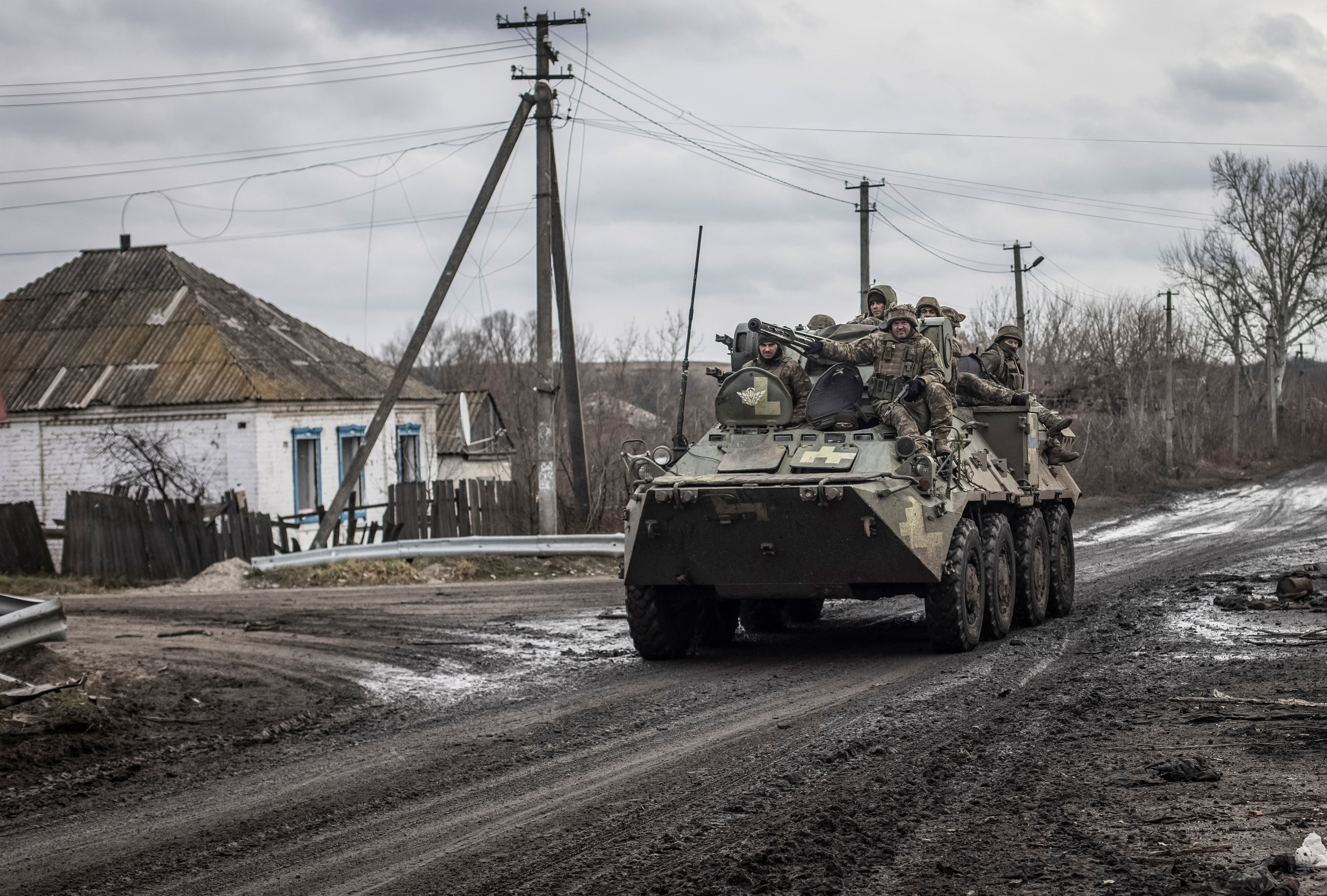 Ukrainian servicemen ride an Armoured Personnel Carrier in the village of Torske