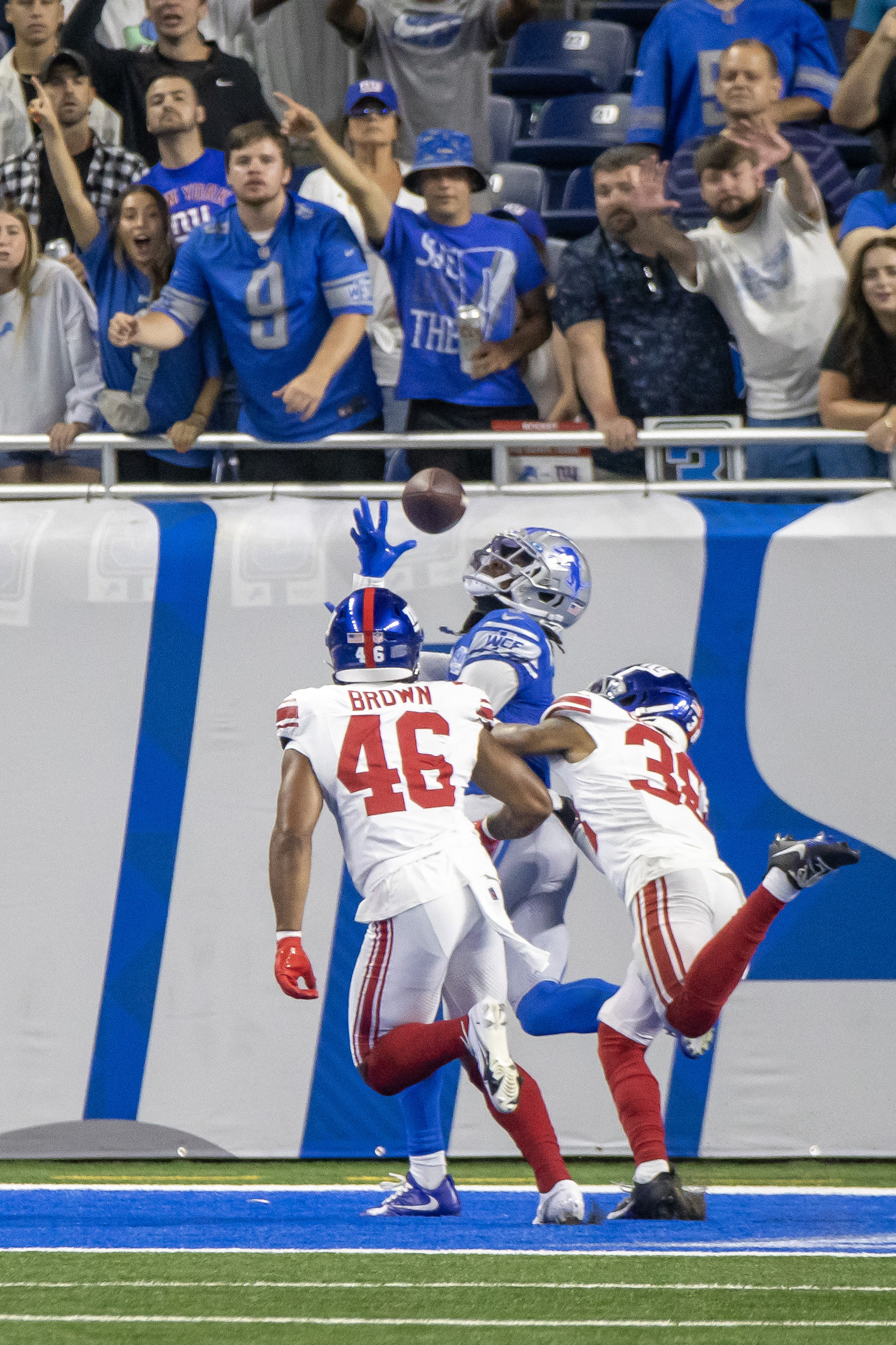 Detroit Lions quarterback Adrian Martinez (18) avoids New York Giants  linebacker Habakkuk Baldonado (45) while carrying the ball during the  second half of an NFL preseason football game, Friday, Aug. 11, 2023