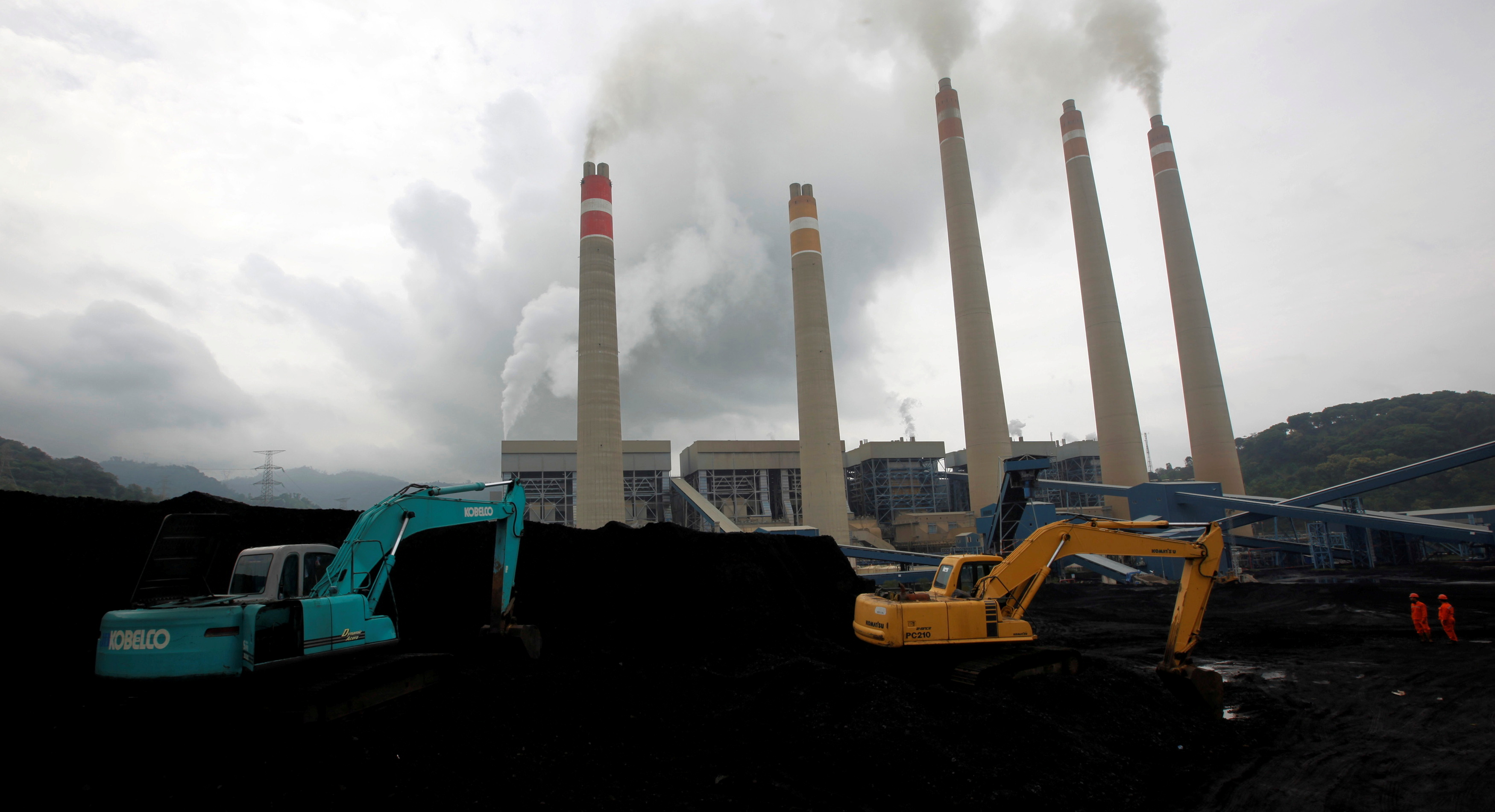 FILE PHOTO: Excavators pile coal in a storage area in an Indonesian Power Plant in Suralaya
