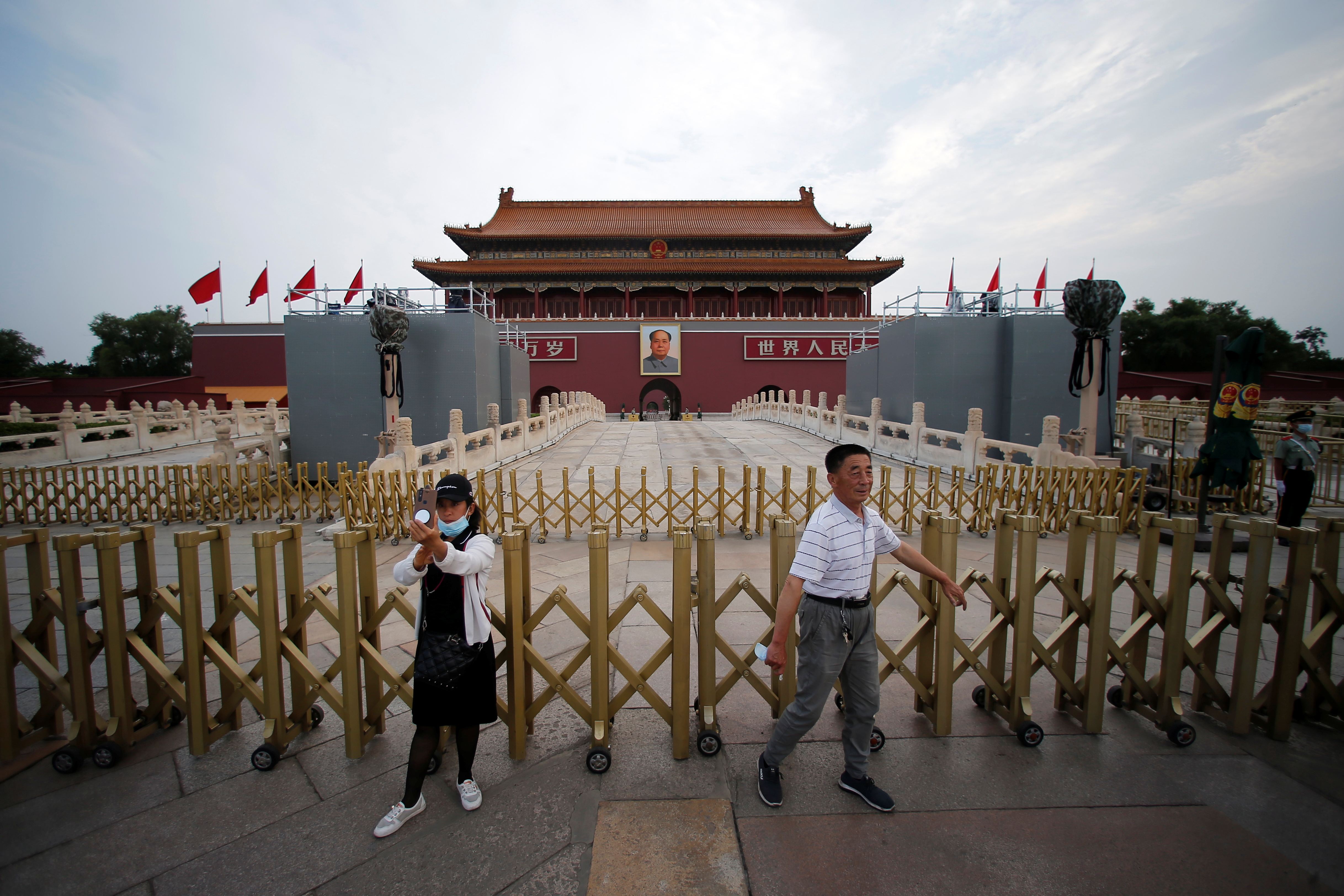 Tourists are seen in front of Tiananmen Gate in Beijing