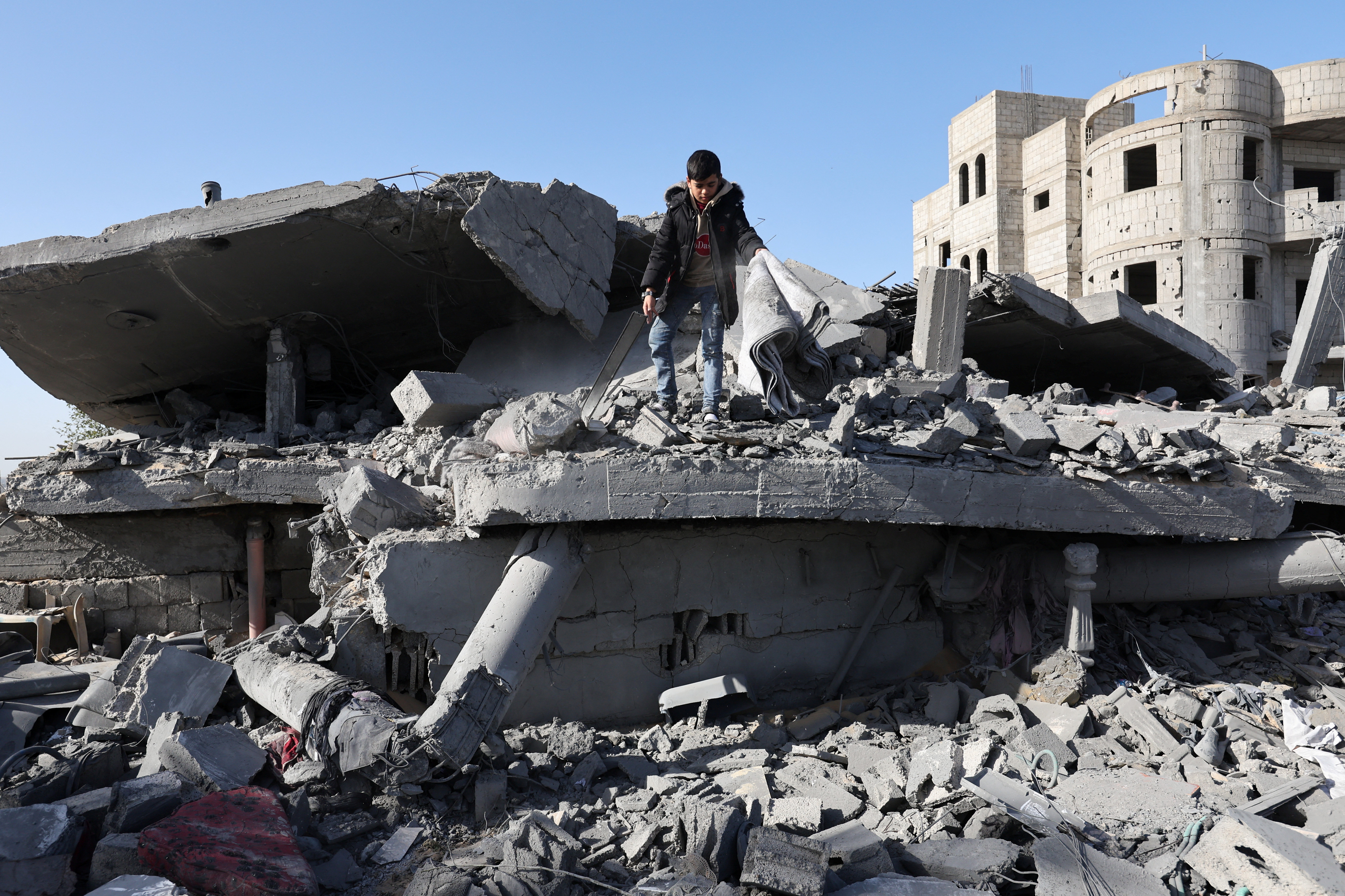 Palestinians gather at the site of an Israeli strike on a house, in Rafah