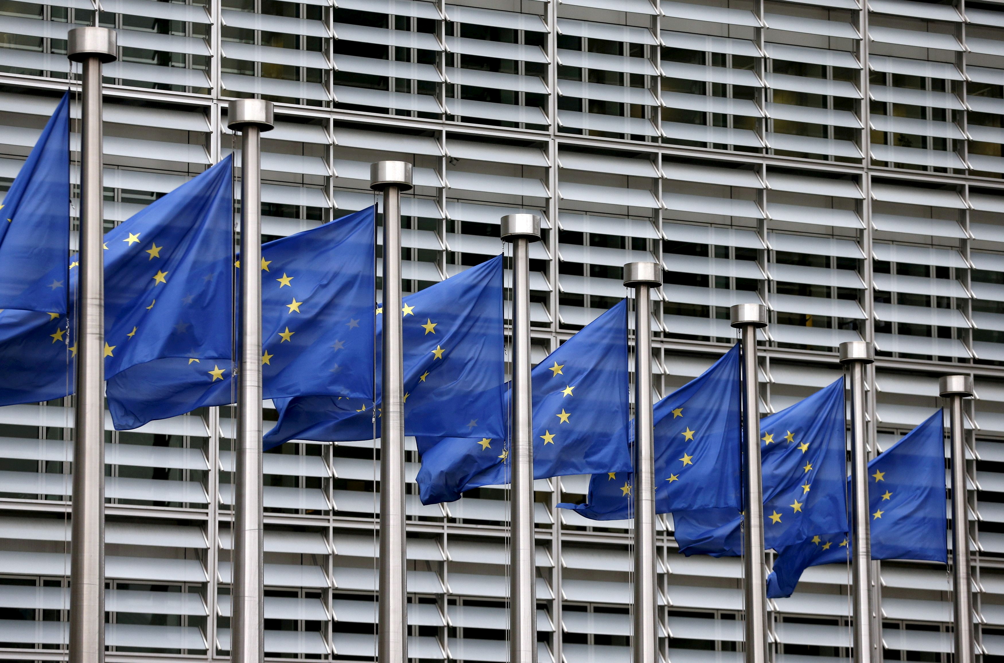 Picture shows European Union flags fluttering outside the EU Commission headquarters in Brussels