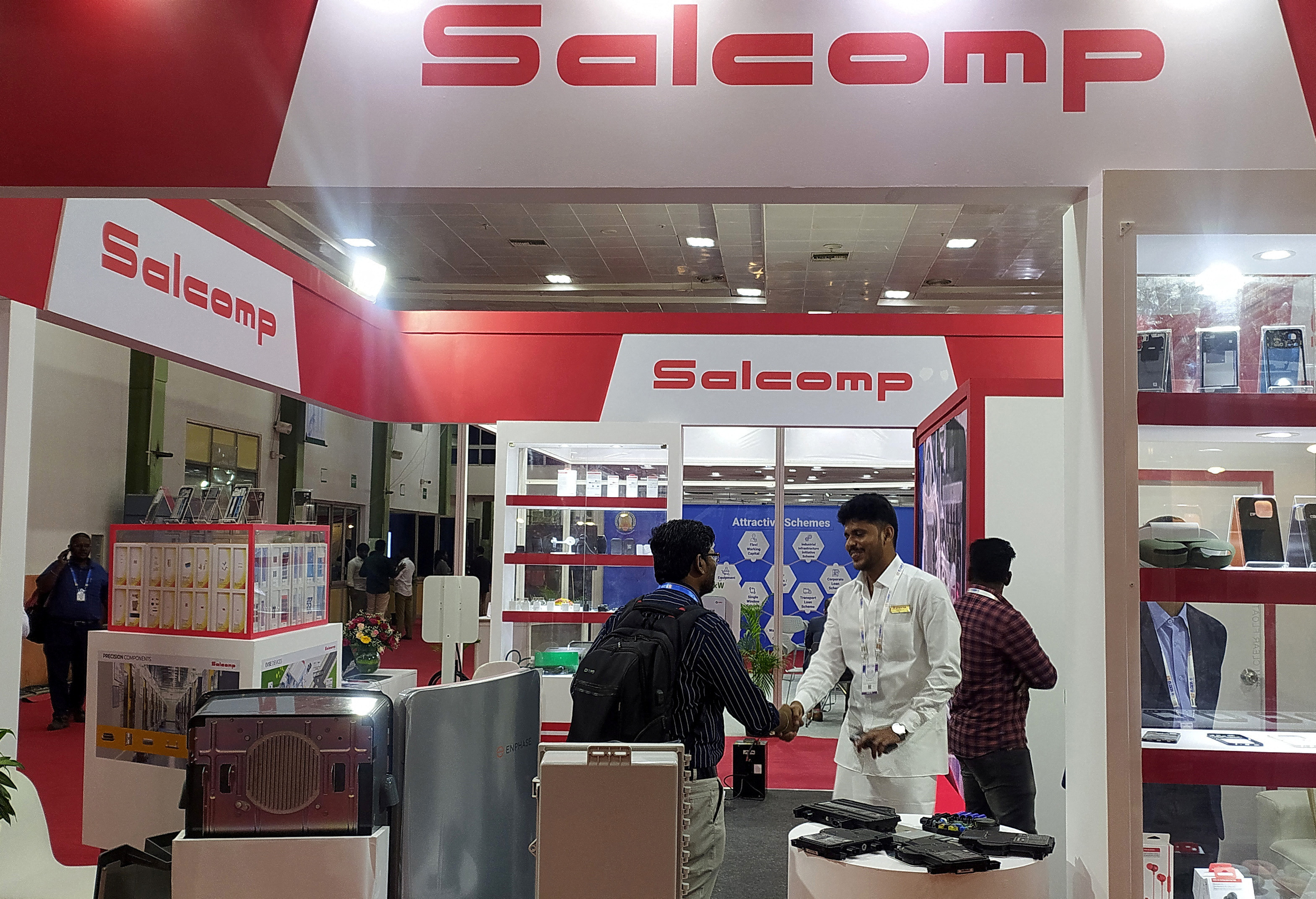 People visit a Salcomp kiosk at an industry event in Chennai