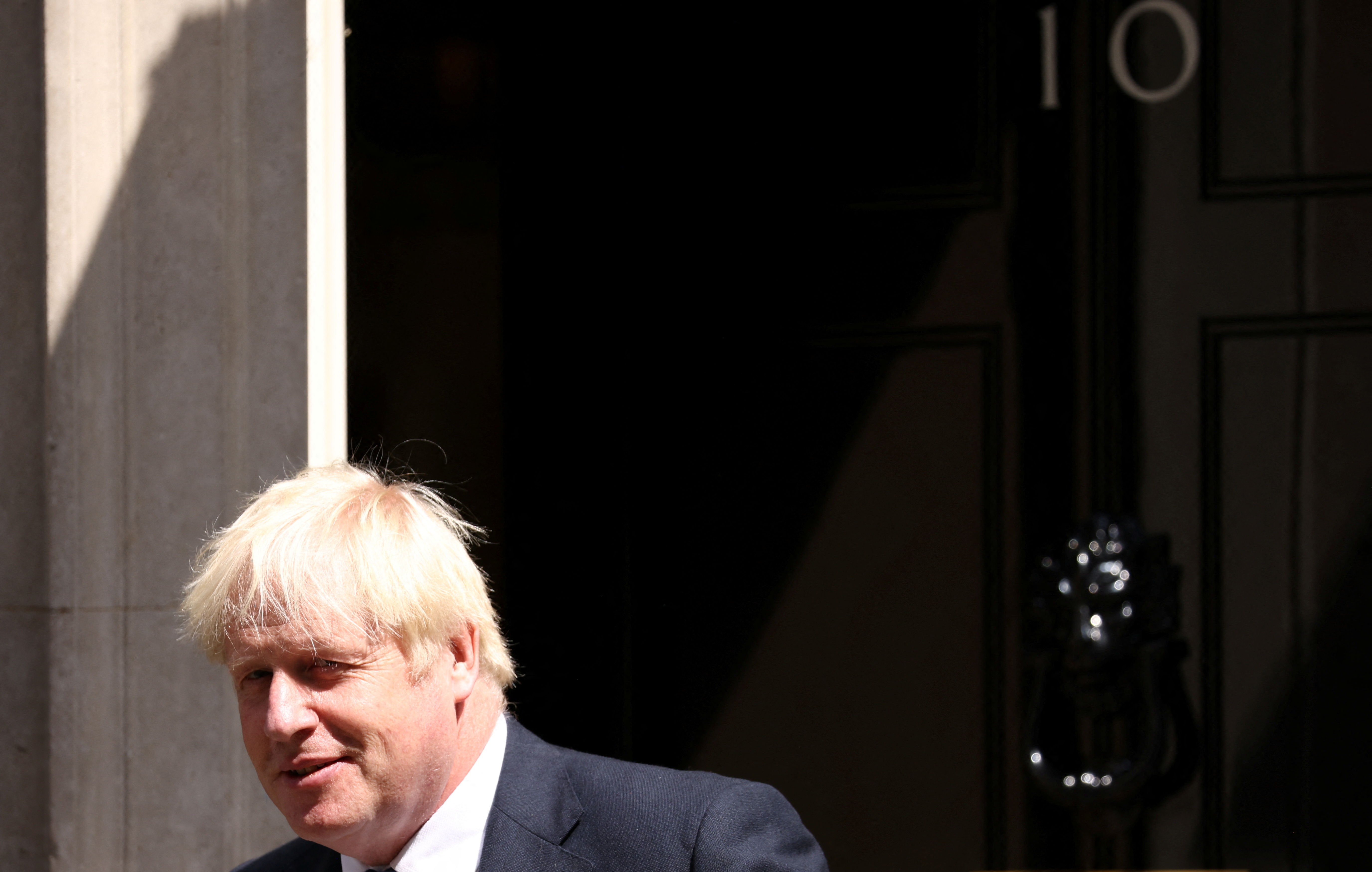 British PM Johnson walks outside Downing Street in London